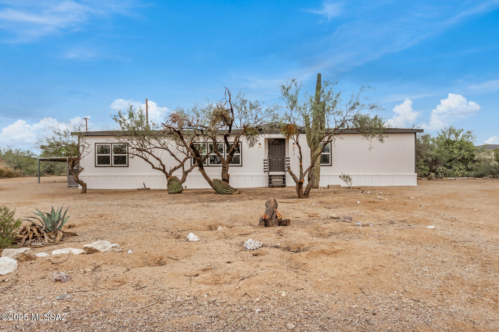Welcome to this remodeled single-story manufactured home, perfectly situated on a HUGE 1.03-acre corner lot! Inside, find an inviting living room that sets the tone for the warm and open layout. Create fun memories in the sizable family room enhanced by a wood-burning fireplace and sliding glass doors that open to the back deck. Features like wood flooring, fresh paint, ceiling fans, and tons of natural light are worth mentioning. The eat-in kitchen comes with plenty of white cabinets and stainless steel appliances, making everyday cooking a delight. Head to the primary bedroom, which includes a six-panel door closet and a private bathroom with dual sinks. Enjoy mountain views from the relaxing deck. Hurry! This turn-key gem is the one for you! Owner/ Agent