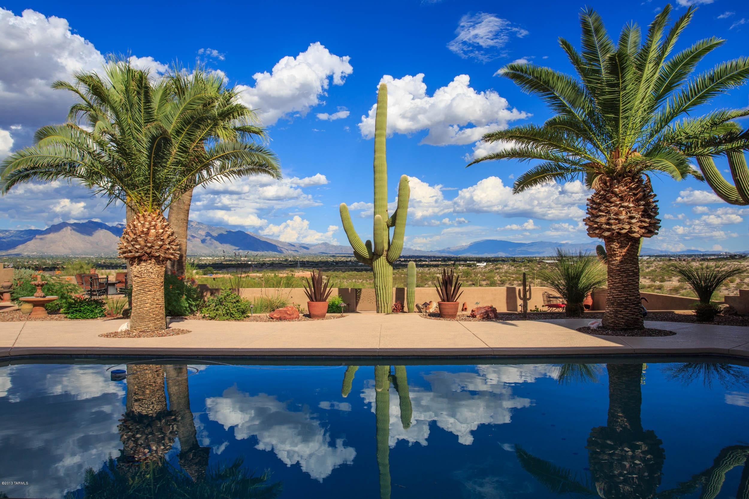 360 degree views,20 mile Catalina Mtn. Views, nothing will be in your view path.  A special property, very private on almost 5 acres,  completely renovated between 2004 and 2008, a Spectacular job of design and innovation. Flagstone entry, Patio,  chiseled granite counters and knoty alder cabinets/doors. 18 inch tile. Open, beamed wood ceiling, game room,( the game room comes with bar and lots of space) and plus a shop possibility in the oversized garage. Back yard is just the best with great views, 10 ft. diving pool-(solar heated), pool area with bar and the Guest house perfectly set in place, lots of space for friends, family and entertaining w/surround sound. Private well. RV garage on site. RV garage is 42x19. See agent remarks