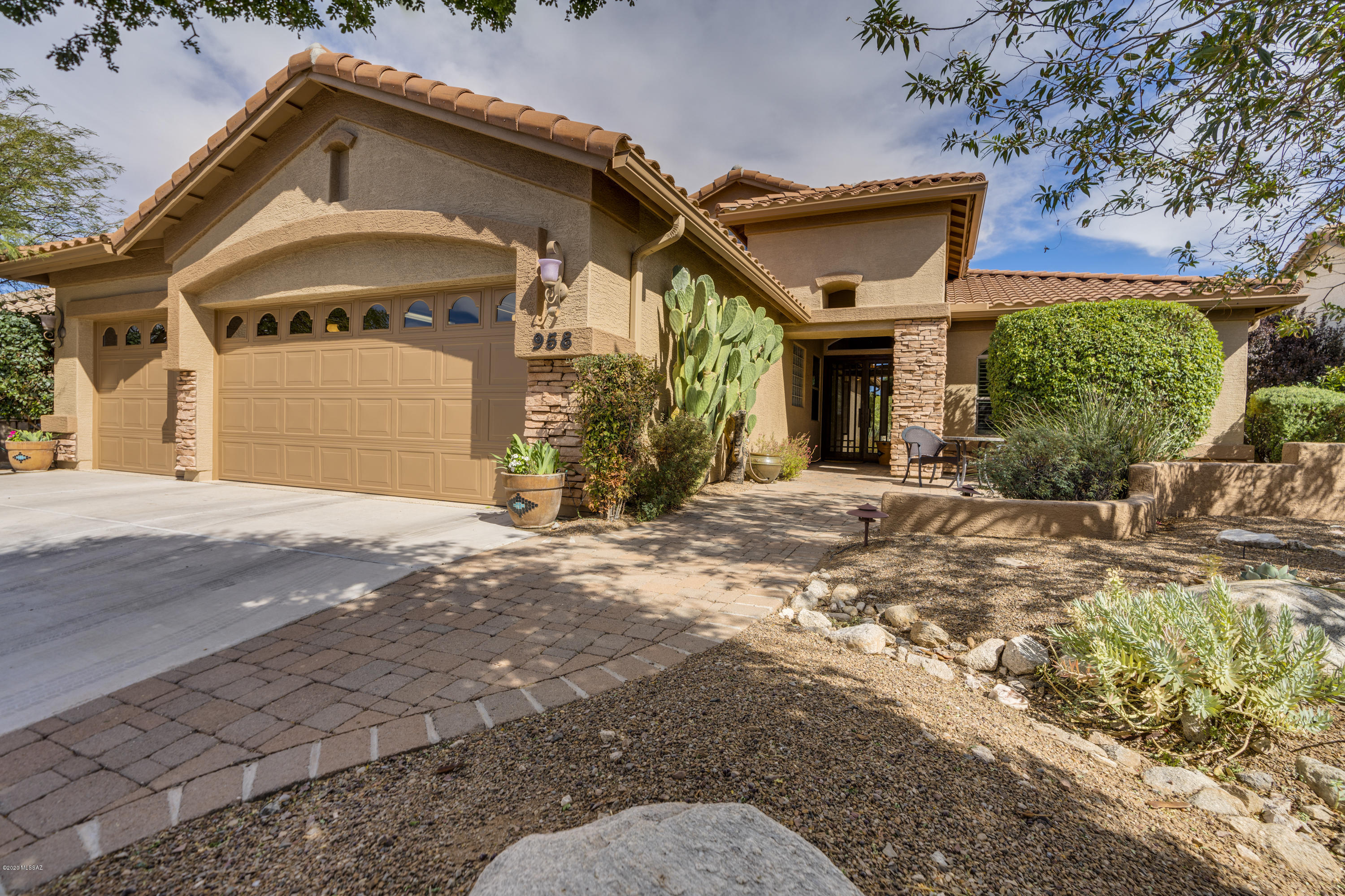 GOLF COURSE, MOUNTAIN AND SUNRISE VIEWS! Beautiful east facing rear patio & extended courtyard offer morning sun, privacy, exceptional golf course &  mountain views, outdoor kitchen, fireplace, soothing sounds from artistic water feature & sunken spa!  Truly magical.   Gracious living, with architecturally inspired front doors, spacious greatroom w/ contemporary entertainment wall, gourmet kitchen, private den, bedroom or second office & a large music, room/library that invites relaxation.   Ensuite master bath w/huge walk-in closet.   Upgrades abound:  upgraded lighting  (LED), cherry cabinets, SS appliances, butler's pantry w/2nd dishwasher, wine fridge, 3 car garage, new roof.
