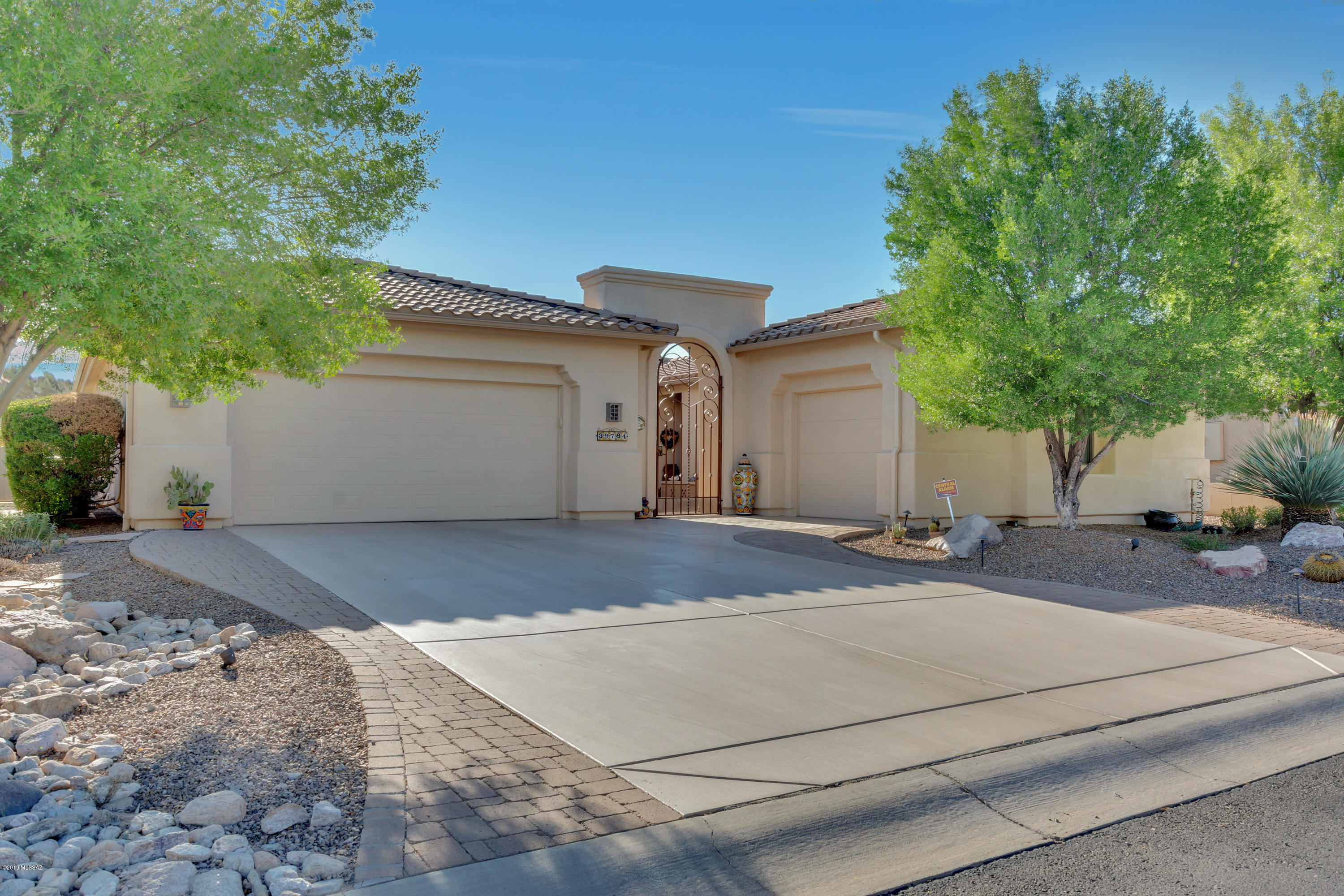 This well kept Charming Cimarron backs up to common desert area with a view of the Catalina mountains to the south. Enter through the gated courtyard and experience the welcoming water feature with pavers leading to the entrance of the home and guest Casita. It's a delight for casual entertaining friends and family. This Cimarron is highly upgraded with built ins in the Family Room, Den/office. Guest bedroom has a  Murphy bed  and was just painted. The Kitchen has Granite counter tops with Alder cabinets that include roll out shelving. A solar tube provide lots of natural light. The family room has a built-in entertainment center wired for surround sound and a area for more formal dining. Exit to the patio with brick pavers and a meticulously landscaped backyard with a view of the mountains to the south. Split full 3 car garage with custom Elfa adjustable shelving to meet your individual requirements, plus a new Rudd water heater with recirculating pump. This one won't last. WELCOME HOME!!!
