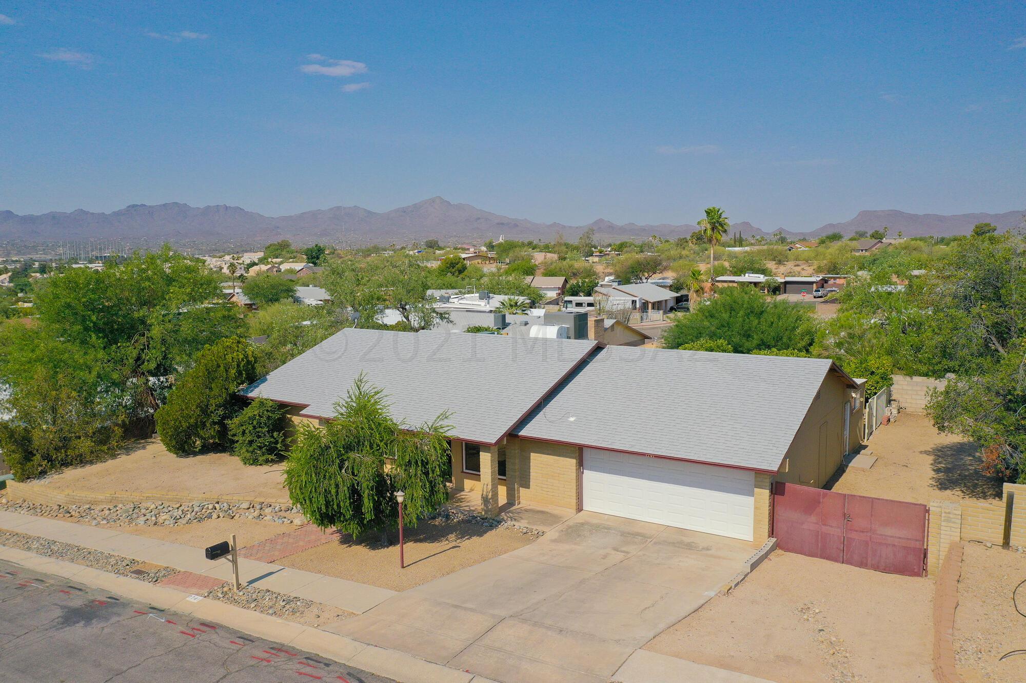 Here is your opportunity to have a home with your own solar-heated pool in your private backyard. This 1900+ SF home offers 3 Bdrms, 2 Baths, Living Room,  Family Room and attached 2-car garage. FR is currently being used as a Workout Room & Artist's Studio. Spacious yard hosts a relaxing & cooling pool along with an ample side yard. And did we mention there is no HOA so no annual dues. Newer roof, newer AC, updated kitchen w/ granite & loads of storage in the custom double-sided peninsula. Lavatories in baths & Master shower also updated. Enjoy lounging poolside in the warm Tucson evenings with views of the Tucson Mountains. Centrally located with quick access to I-10. Seller will entertain offers from $300,000-$325,000 and will review all submitted offers by 2:00 pm Tuesday, June 22.