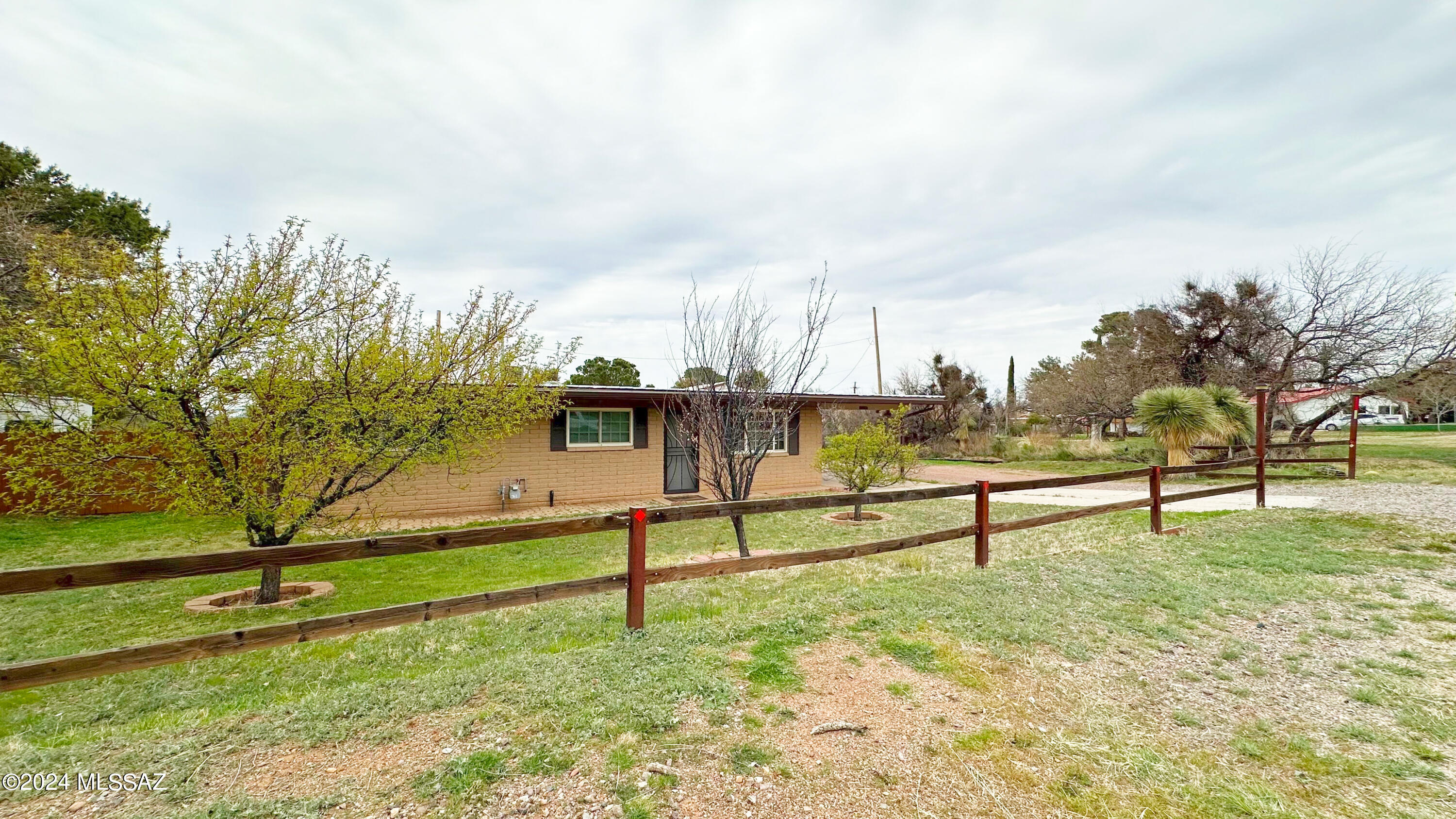 This lovely and reasonably priced slump block single-family home is now available in the charming town of Oracle, AZ. There are three bedrooms, each with walk-in closets and two full bathrooms, and the second bath features a Jacuzzi walk-in tub. The functional U-shaped kitchen offers ornate detail cabinetry, Corian countertops, a gas range, and a white appliance package. The house boasts updated 20''x 20'' tile flooring, updated dual pane windows, fresh neutral paint, ceiling fans in each room, a cozy wood-burning fireplace in the living room, and proximity to Mountain Vista Elementary School. The house also offers a nice view of desert open space across the street. A laundry/utility room with a washer/dryer is just off the carport, with plenty of extra parking in the front and abundance of established fruit trees. The property doesn't have an HOA, so bring the toys. The backyard is entirely fenced, has an enclosed garden area, and a screened and enclosed AZ room accessible off the dining room. The icing on the cake is a separate 20' x 25' x 12' high workshop garage. Come and explore Oracle State Park, beautiful mountain ranges, hiking/biking trails, and caves, and enjoy all the beautiful boulders and greenery Oracle, Arizona, has to offer. Owners are licensed Realtors in the state of AZ. Alarm installed.