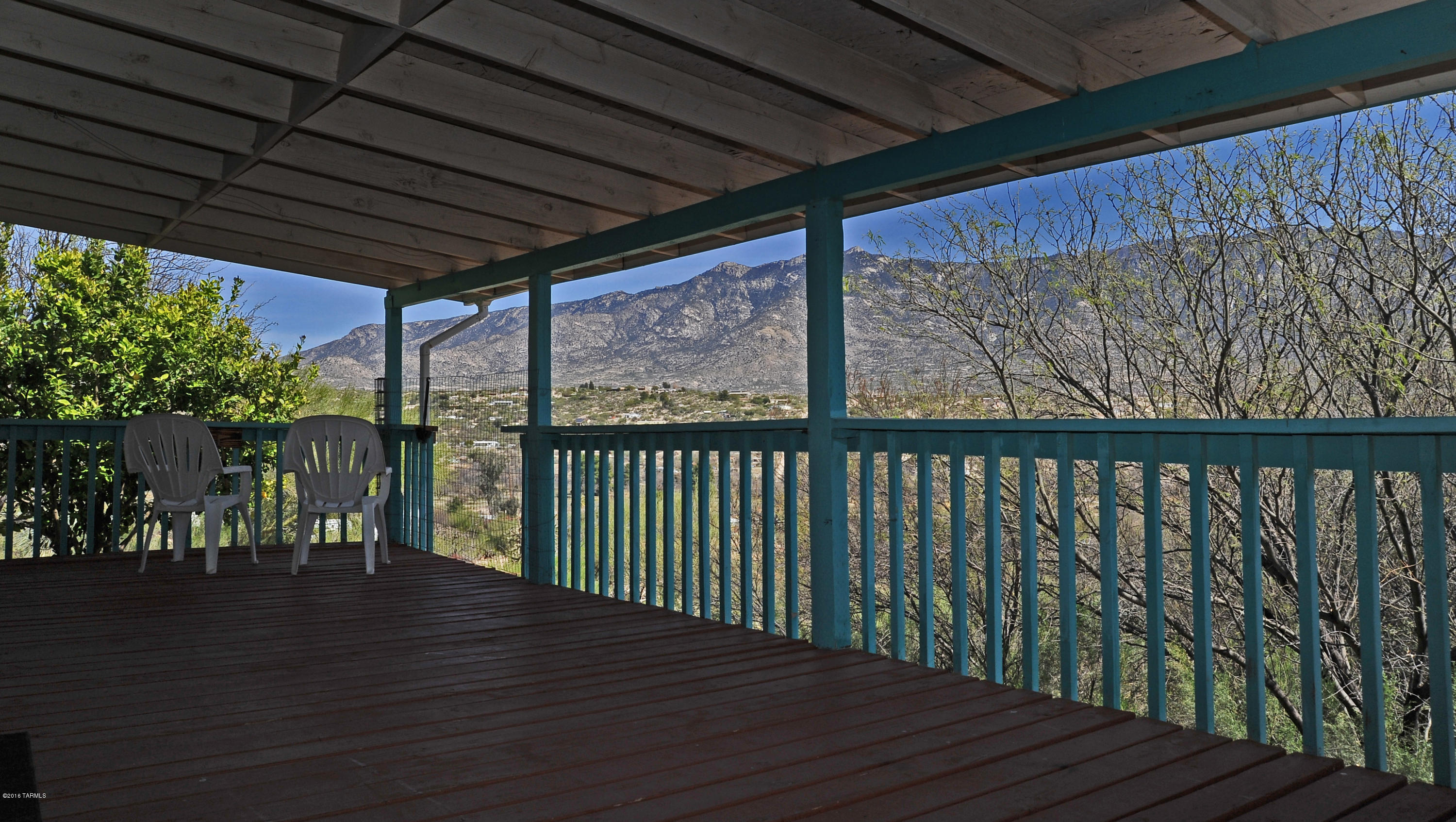 Enjoy unobstructed views of the Catalinas lounging on your east-facing, full-length covered patio; open floor plan features soaring vaulted ceilings with laminate flooring in the entry & kitchen and carpet in the great room & bedrooms for comfort; well-lit, functional kitchen features an island & lots of counter space; AC and dual-pane windows provide affordable summer comfort; citrus trees & landscaping rock already in place; long driveway for lots of visitors; serene country living with great star gazing - watch full moon rise over the mountains from your deck; eligible for FHA/VA financing; <10 min from shopping and healthcare.