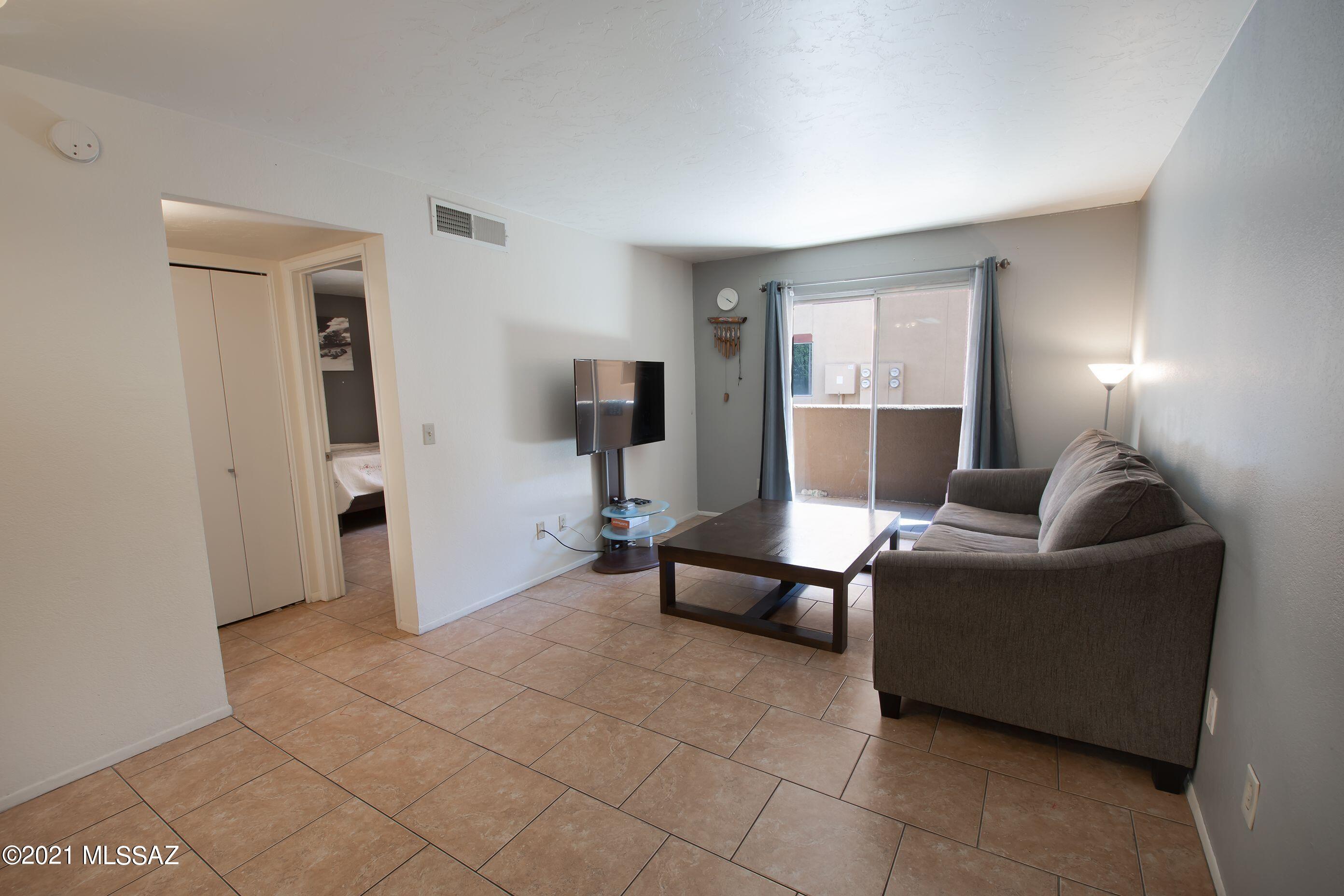 Welcome home! This 2 bedroom, 1 bath condo. unit is light and bright, low care, and move-in ready! There is an open living room/dining area with tile throughout. The enclosed patio offers a quiet retreat along with an additional storage/closet space. This location is on the ground level and within the gated community of Casa Club. This community provides access to 2 swimming pools and spas, a tennis court, a volleyball sand court, exercise facility, laundry facilities, and a clubhouse. The property is conveniently located in Central Tucson, within close vicinity to the University of Arizona, University Medical Center, among others. There are restaurants, shopping, and many other services nearby. Plan to see this condo. today - it won't last long!