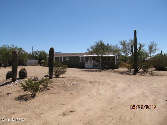 TOTAL REMODEL. NEW ROOF, NEW WATER HEATER, NEW interior custom paint, 2 tone. NEW exterior paint. NEW custom counter tops, NEW sinks & faucets, TONS of cabinet space. NEW interior doors & knobs. NEW insulated front & back doors. NEW luxury simulated wood, Allure flooring. NEW Plantation Blinds. NEW STOVE & DISHWASHER. NEW porch lights. NEWER central Heat/AC 6 years. Carport will accommodate 2 smaller cars. Lot fenced on 3 sides with fully fenced back yard. Gorgeous Mesquite & Palo Verde trees & Saguaro cactus. Ideal Family or Snow Bird Home. 1 year Home Warranty with full price offer. Verify horses are OK.