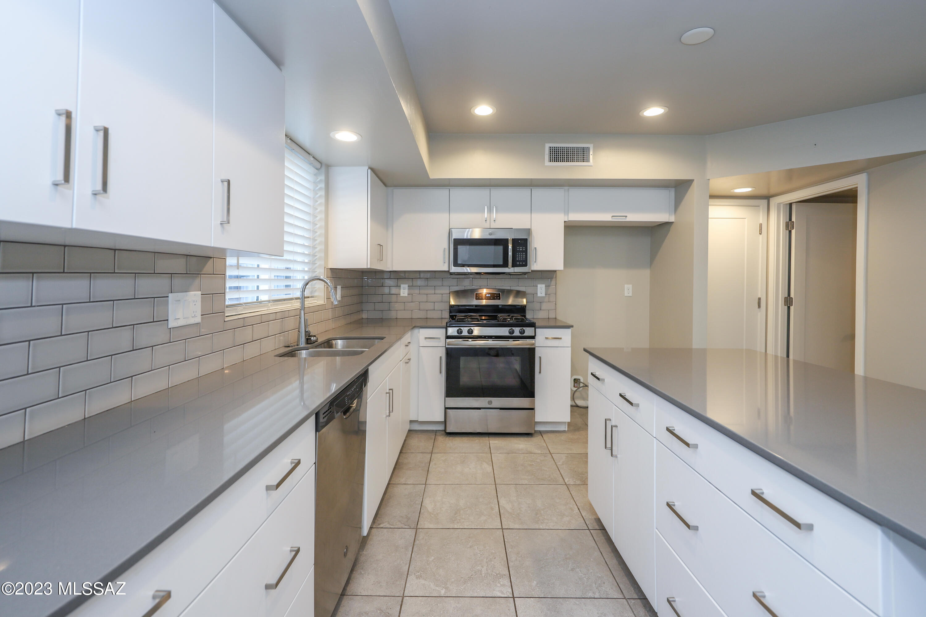 Modern 2 story home centrally located. This home features 2 bedrooms each with their own bathrooms, laundry room (washer and dryer stays) and an office space upstairs. An open floor plan downstairs includes living room, spacious kitchen with lots of cabinet space and half bathroom. Includes Tesla wall charger in garage. Low maintenance private side yard and a 2 car garage. Close to restaurants, shopping and the U of A. This home has approximately $315K on an assumable VA loan at 2.75%!
