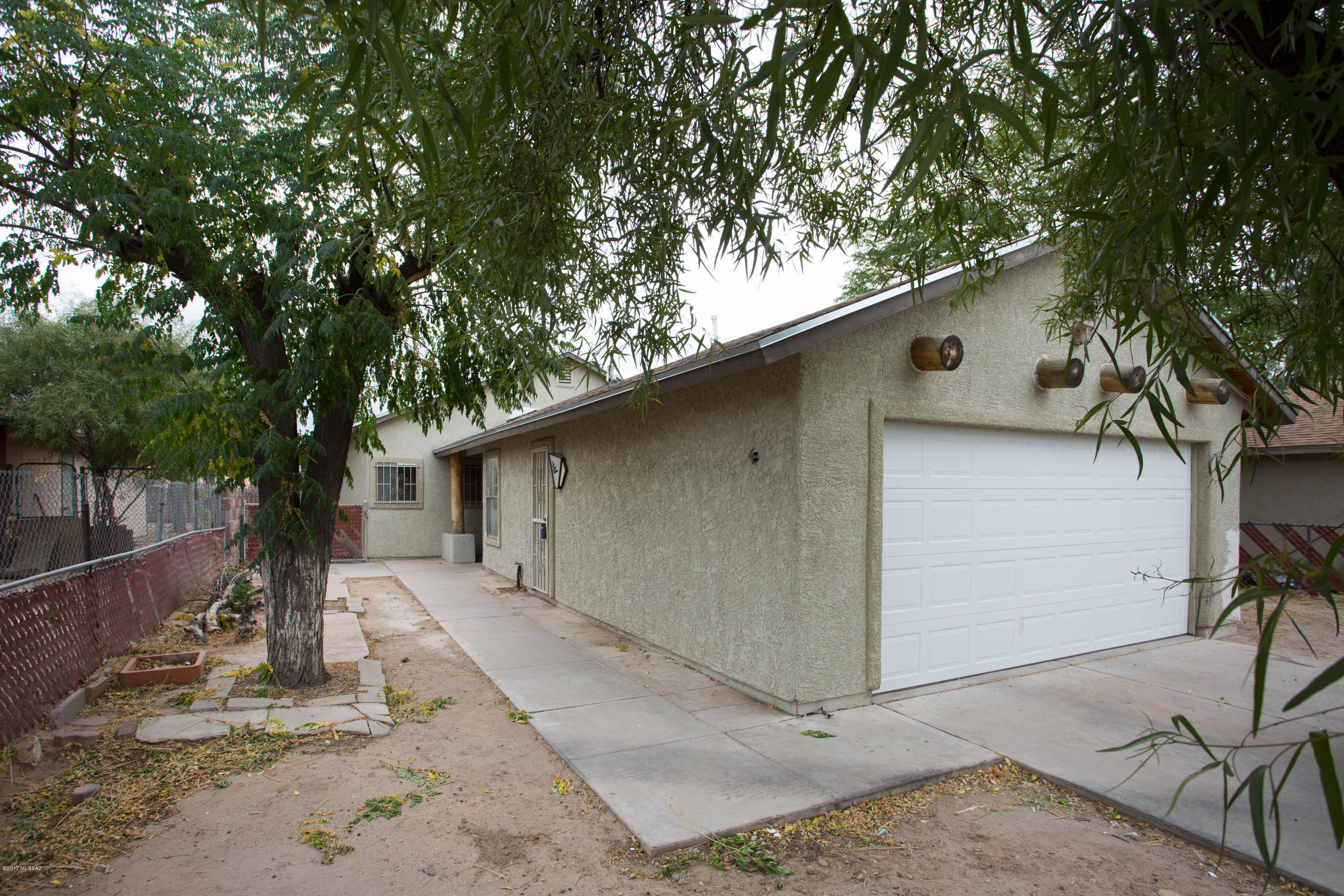 Investor or first time special! Three bedroom home with 2 full baths close to all. With some cleaning, paint and a bit of décor- this home would be very cute and you could have instant sweat equity. Living spaces have vaulted ceilings, French doors and stylish built ins. There is no carpet in this home- just easy care tile throughout living spaces, kitchen, baths and guest bedrooms. Master suite features wood laminate floors, vaulted ceilings, walk in closet and private full bath with soaking tub.  Kitchen offers tile counters, decorative tile backsplash and appliances including fridge and gas range. Extras- attached 2 car garage, security doors, mature trees, private outdoor space.