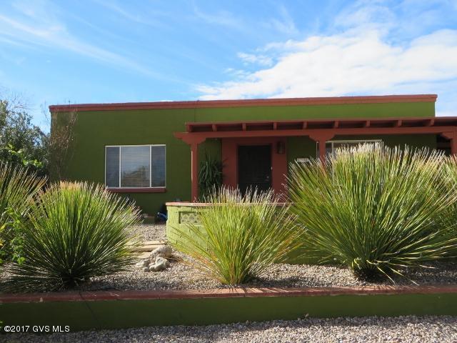 Mountain views & front & rear patios await you in this adorable energy efficient home ready for year round or seasonal owner. The block constructed home has been upgraded with dual pane windows, newer heating/cooling and solar system for great energy savings! Inside appreciate a newer kitchen remodel with granite counters, stainless steel appliances (refrigerator/gas stove/dishwasher) pull out drawers, large pantry, breakfast bar & double sink with newer faucet. There is also a tastefully done permitted Arizona room with lots of windows to view the mountains, the 2nd bathroom & laundry rm with storage. Outside relax on the front North facing walled patio or roam around the large rear yard with mountain view & a storage shed. Located close to the GVR East center and quick access to I19.