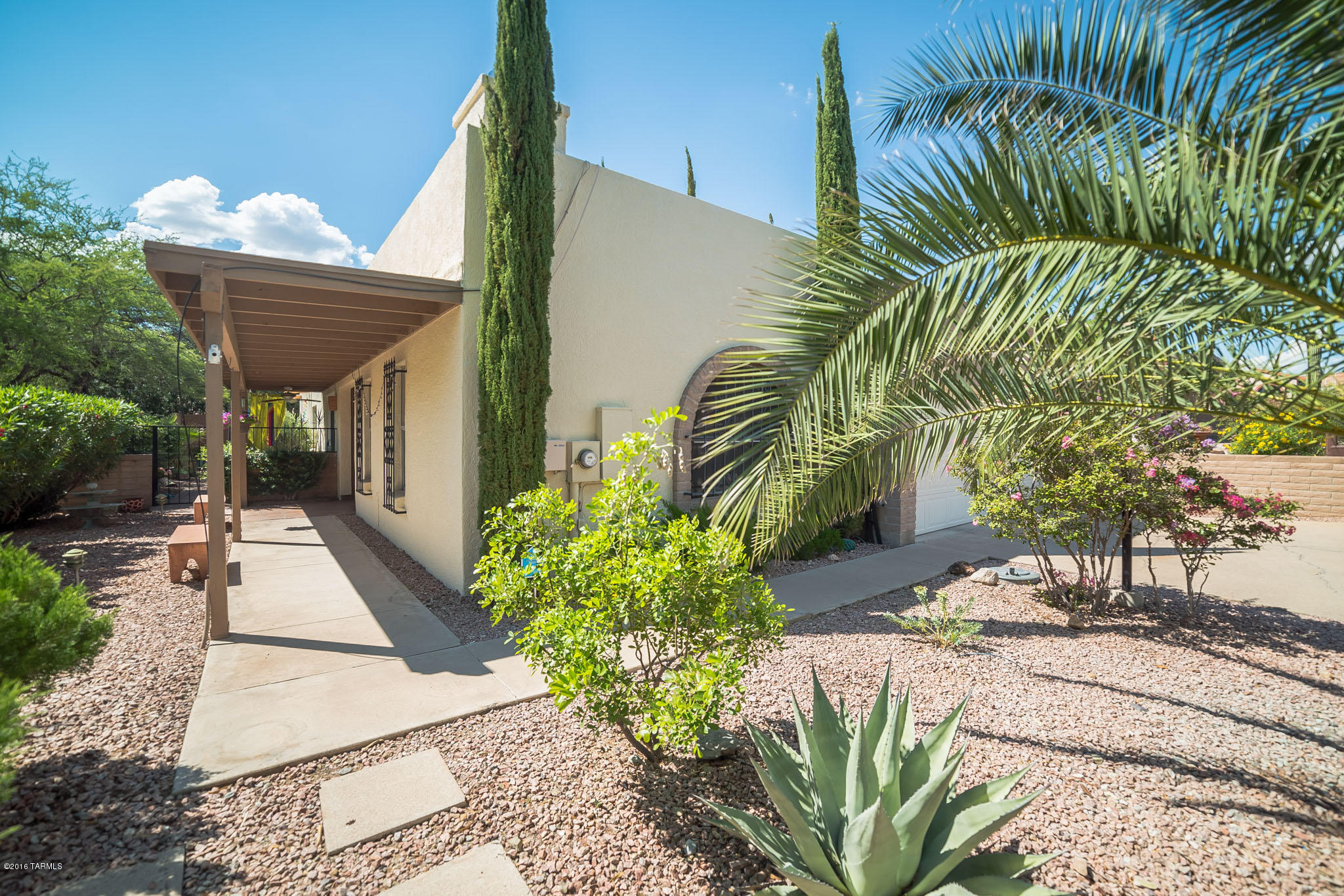 Come take at look at this one of a kind, end unit townhome with an amazing sense of privacy and views of natural desert to the South. Natural sunlight fills this home through large windows and skylights along with a cheerful atrium that is visible from the living room, dining room and kitchen. And talk about the kitchen - wow! The kitchen has been updated with beautifully crafted white cabinetry; Corian counters; center island with glass cooktop; double wall ovens and contrasting black appliances. You decide where you want to have a bite to eat - the kitchen bar, the breakfast nook or the open dining area adjacent to the kitchen. An expansive master bedroom has extra room for a sitting area or exercise area and the master bath has been updated with granite counter, stainless sink and walk in shower. The large guest bedroom has access to the Arizona room which also provides additional room for an office as well an entertaining. The outdoor spaces are simply delightful. From the fabric stretched sunshade on the north end of the patio, to the wrap around patio on the south you will feel so relaxed and at peace.