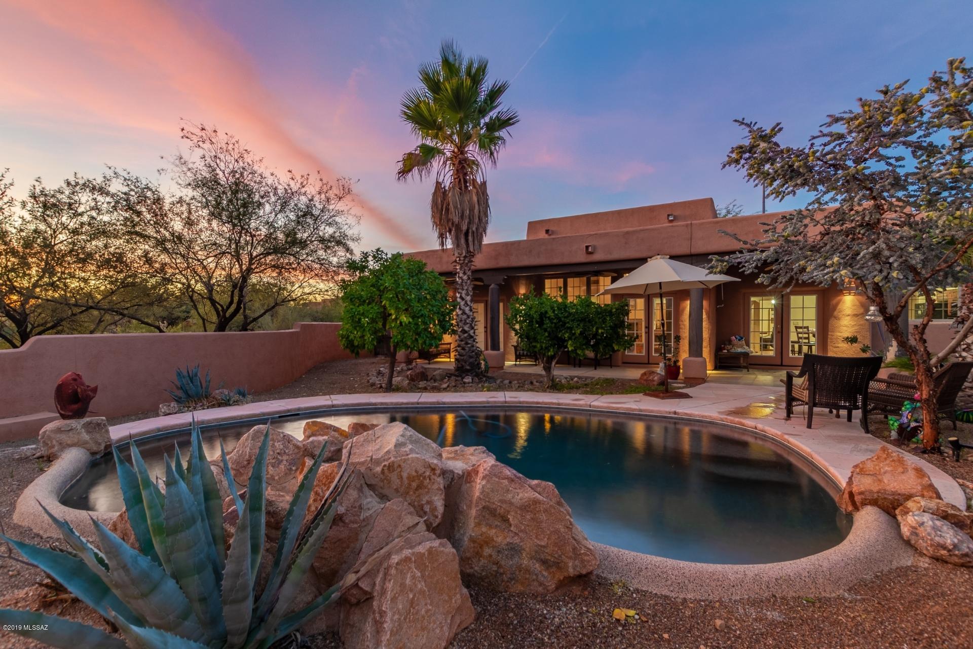 You don't want to miss this unique southwestern style home on over an acre of mountain view property. Savor privacy and tranquility all within easy reach of shopping and restaurants. The outdoor space is like a desert oasis. Secluded backyard offers a covered patio, a sparkling private pool and majestic mountain views. Inside is immaculate! The open floor-plan boasts over 2000 sqft of living space, 3 generously sized bedrooms and a spacious great room with rustic log beamed ceilings and a charming fireplace. Gorgeous tile floors flow throughout the entire home. Impressive kitchen features tile countertops, beautiful custom cabinetry and a breakfast bar. Elegant master retreat includes a private ensuite and charming french doors to the backyard. This rare gem will sell fast. See it today.