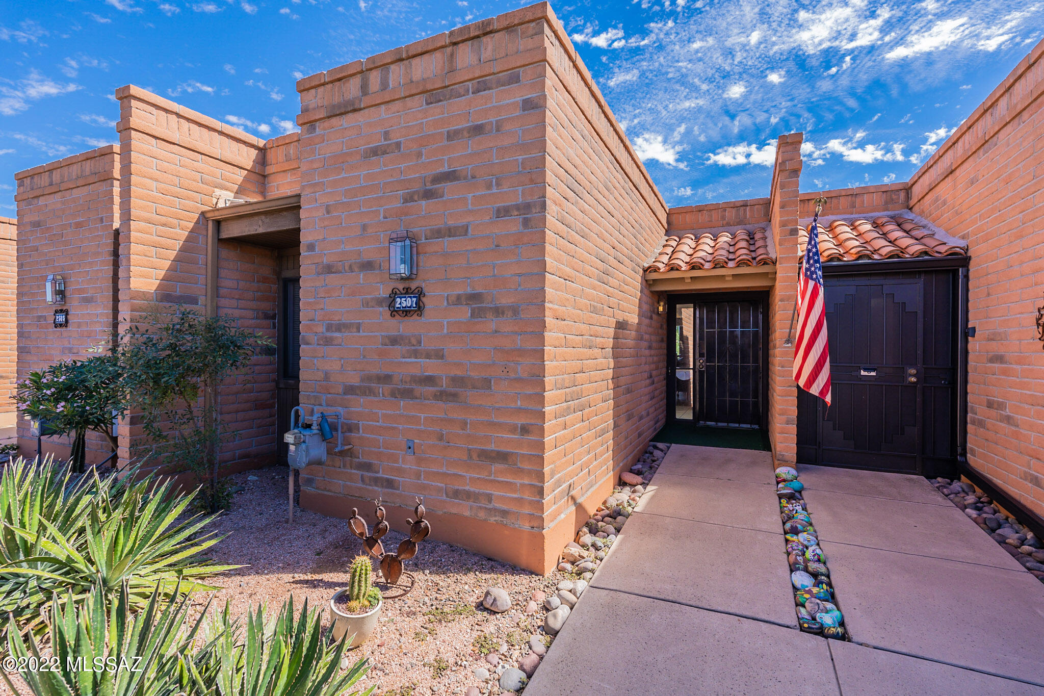 The perfect desert getaway! Gorgeous setting sitting high above the DH golf club driving range and looking straight at the Santa Rita Mountains! This is a casita like no other! You will surely spend most of your time on the back patio, entertaining or simply gazing at your incredible mountain view! The living area is spacious enough to host your guests and the views are front and center. Beautiful new flooring and taupe paint give this unit a fresh and modern feel, while the glossy red kitchen cabinets are just the right amount of glam.  This home offers the perfect combination of low maintenance and spaciousness-all surrounded by those breath-taking views!