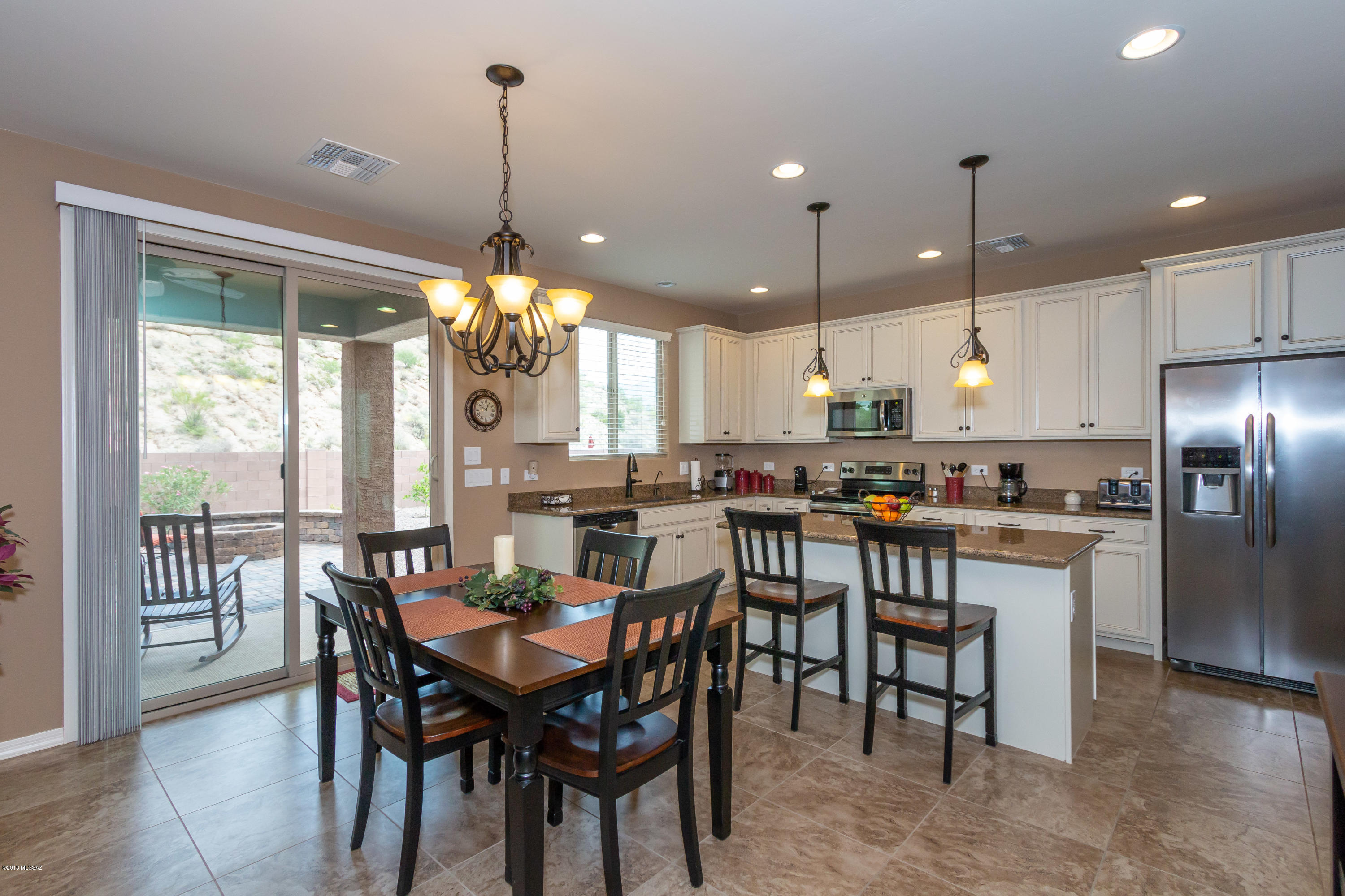 GORGEOUS move-in ready home w/stunning mountain views! 4bd, 2.5ba  w/formal DR. Beautiful premier cabinets, island, pendant lights, granite counters & SS appliances. Upgraded bronze hardware & fixtures along w/black iron stair balusters & 2-tone paint extend a consistent elegance throughout. Huge loft, STORAGE galore, upgraded carpet pad, window coverings, 4' ext garage, water softener & R/O system add to the appeal of this home. Extended patio w/ceiling fans, coupled w/orientation of home, provide shade nearly all day. From the professionally installed paver patio, a vast Catalina view opens to the SE with Tortolita sunsets to the west. Citrus trees/desert flora, fire pit in back. A MUST-SEE! Also available FULLY FURNISHED (furniture/appliances) under separate bill of sale.