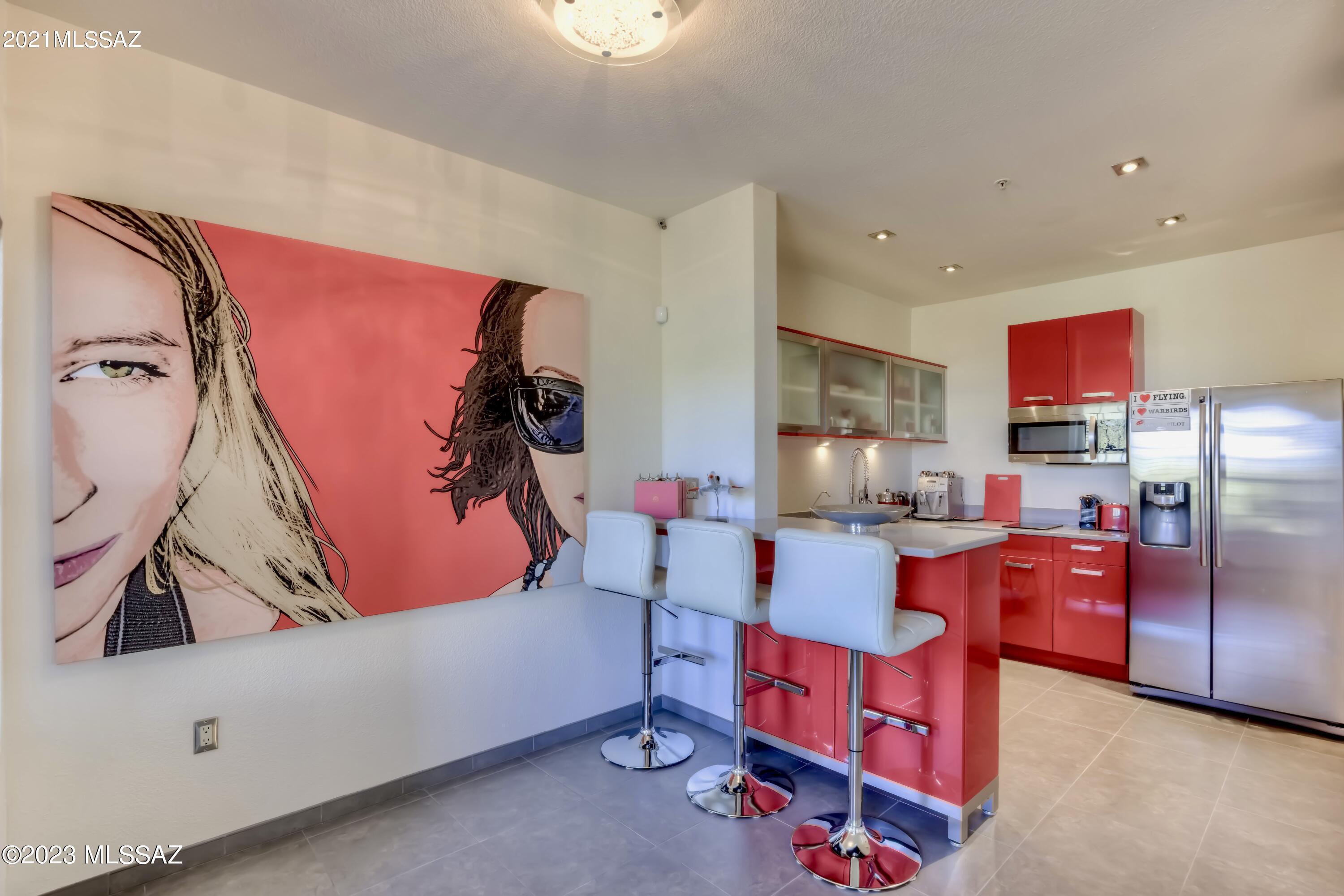 One-of-a-kind high-end remodeled condo with special attention to every detail in prestigious community of The Boulders at La Reserve, only minutes away from Catalina State Park with fabulous cycling trails, great for birdwatching, hiking, and a healthy lifestyle. This 1BR/1BA condo features a premier-quality style kitchen w/ red custom-made cabinets, quartz countertop, stainless steel appliances, built-in drawer dishwasher, water purifier. Modern bathroom w/ walk-in rain shower. Wild cherry red LG washer + dryer, mirror walls, glass doors, recessed lighting, ceiling fans, 18'' ceramic tile floor throughout, walk-in closet, screened-in balcony and so much more! DETAILED DESCRIPTION UNDER DOCUMENTS! Exceptional amenities include community pool, spa, BBQ area, gym and a beautiful clubhouse. THE HOME

Ø	One-of-a-kind high-end remodeled second floor condo
Ø	Extreme attention to every detail
Ø	Contemporary stylish, chic, and sophisticated
Ø	Move-in ready, fully furnished, exquisite custom-made Closet Trends Cabinetry  
Ø	Big windows for natural light, 9 ft ceilings 
Ø	Winter grey Metro Platinum 18" ceramic tile floor throughout 
Ø	Frameless satin glass doors with chrome in bathroom and bedroom   
Ø	Recessed lighting
Ø	Designer ceiling fans, brushed nickel
Ø	Wild cherry red LG Electronics Steam Washer and Dryer, ENERGYSTAR
Ø	Bradford White Corp. 50 gal. water heater with Hydrojet Total Performance System 


THE KITCHEN

Ø	Premium design red acrylic custom-made kitchen cabinets by Affinity Kitchens, Scottsdale 
Ø	3 cm Silestone Kensho Quartz countertops
Ø	Breakfast bar with elegant chrome barstools 
Ø	Stainless steel appliances 
Ø	Samsung 25.5 cu. ft. side by side refrigerator 
Ø	Fisher Paykel semi-integrated single DishDrawer, 7 place settings, 9 cycles 
Ø	Sunpentown 1300 watt countertop induction cooktop
Ø	LG Electronics 1.7 cu. ft. microwave oven
Ø	Reverse Osmosis Water Treatment System by Water Tec Tucson (water purifier)


THE BATHROOM

Ø	Large walk-in shower with Hansgrohe Raindance showerhead + handheld shower system
Ø	Floor to ceiling frameless clear shower glass wall and door with chrome finish
Ø	Large wall to wall mirror with modern LED lighting by George Kovacs 
Ø	Custom-made red acrylic bathroom vanity cabinets by Affinity Kitchens, Scottsdale 


THE STUDIO/BEDROOM 

Ø	Ulisse queen tilting wall bed with vertical opening system in melamine white finish by Resource Furniture, New York (by day the bed simply disappears, leaving a cabinet depth of only 12 inch)
Ø	Floor to ceiling wall mirror to expand the sense of visual space in bedroom/studio
Ø	Access to screened in balcony to enjoy breathtaking Arizona sunsets 
Ø	Walk in closet with custom-made white cabinets and shelves by Closet Trends Cabinetry  
Ø	Designer glass desk


EXTRAS 

Ø	Security Alarm System, Cameras
Ø	Fire Sprinklers
Ø	Designated carport #118 


THE BOULDERS AT LA RESERVE

Ø	Breathtaking picturesque Santa Catalina Mountains views at the base of Pusch Ridge 
Ø	Resort-style living in a prestigious Oro Valley community among million $ homes 
Ø	Amenities include a tranquil heated pool, spa, a beautiful fountain, picnic and BBQ area
Ø	Spacious clubhouse with library, business center, fully equipped kitchen, big lobby for entertaining - can accommodate large social events 
Ø	Fitness center with separate weight room
Ø	Completely landscaped with low care desert plants, cacti, Mesquite and Palo Verde trees
Ø	Upscale neighborhood, only minutes away from fine restaurants, elegant shopping and world-class golf courses
Ø	Next to Catalina State Park with numerous fabulous cycling trails, great for birdwatching, hiking, and a healthy lifestyle