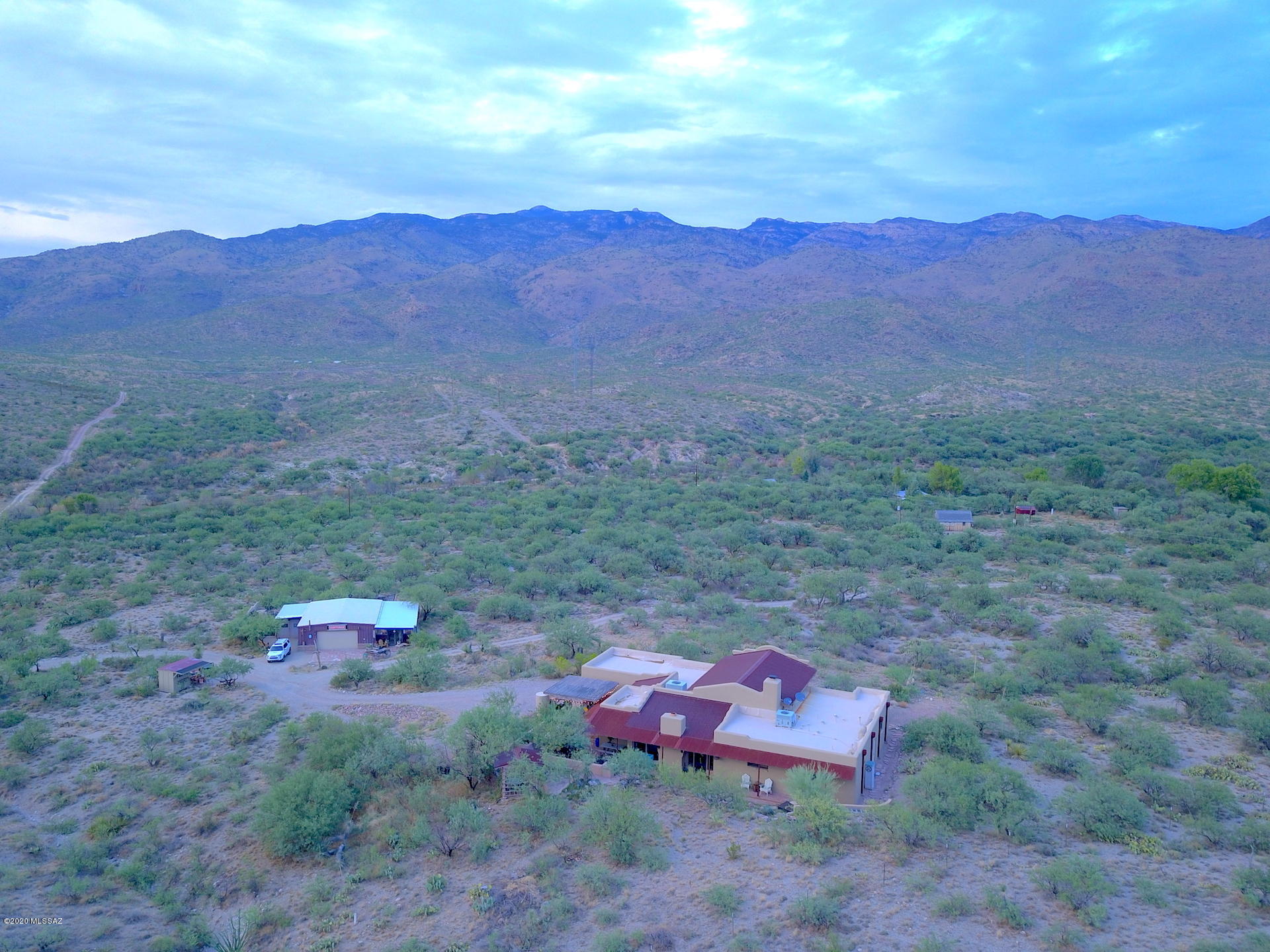 An amazing 15+ acre ranch with panoramic mountain views in every direction, a horse ride away to the National Forest. Privacy and all the room you could want in this rural paradise filled with streams, rolling hills, terrific wildlife and jet black night time skies. Fenced pasture for horses.  This custom Rastra Compound Insulated Concrete Forms (ICCF's) block construction home has superior energy efficiency with its economical and environmentally-friendly construction.  The home features 2 bdrms./3baths, spectacular great room with 19' vaulted beam ceilings, stacked stone fireplace and polished concrete with inlaid pavers.  The dreamy chef kitchen  with a 12' granite bar and GE monogram appliances. Relax and enjoy being able to see the wildlife up close and daily sightings of whitetail deer while in the charming AZ room with fireplace and wall of windows.  Luxurious Master retreat has bathroom with double sinks, walk in twin shower and his/her closets.  Office has granite and built-ins.  Enjoy sunsets from the side patio with grapevine arbor and premium outdoor kitchen. 
 4 car garage plus a garage/workshop with 220 electric.  All of natures best and just a short commute to Tucson and close to the new Houghton Corridor Shopping Developments, this is a must see. Home is a 2 bedroom with office and Arizona Room.  Arizona room can be turned into the 3rd bedroom.

Custom made furniture is available to purchase separately.  

Sale is for two (2) parcels.  Parcel #1 is 5.47 acres (lot dimensions are  626, 464, 524, 319, 90, 45, 81) and is the parcel where the house, garage & shop sit.  Parcel #2 is 9.88 acres (lot dimensions are 467, 858, 467, 476, 104, 319, 81, 45, 11).  

Dimensions of the following:
* Shop 30' x 40'
* Carport Garage 14' X 20'
* Separate Enclosed Storage on E side of Shop 14' X 38'
* Size of Rasta Block 12" wide X 15" high X 90" long.  All Rasta walls are grouted with solid concrete.
* Lot dimensions for Parcel #1

The legal Description for both parcels are:
* From Parcel:30601006X /Ely Ptn Se4 Ne4 Sec 13-16-17 & W107' S370.23' N2148.56' Lots 1 & 2 9.88 Ac Sec 18-16-18
* 30612007M /Ptn W591.30' S464' N2148.56' Lots 1 & 2 Exc E30' 5.47 Ac Sec 18-16-18