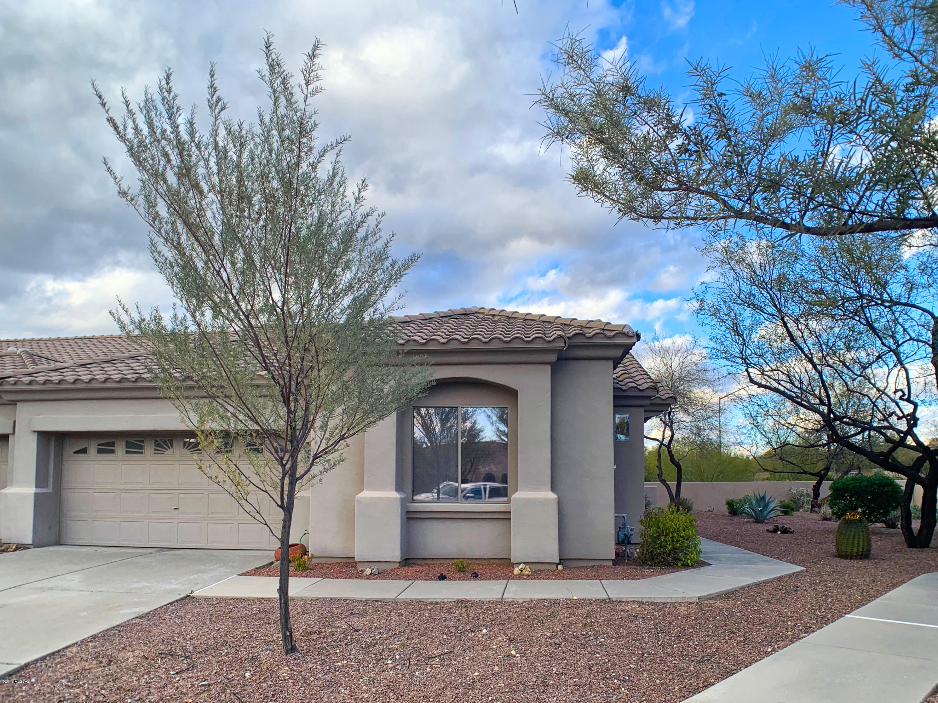 Mountain View move-in ready Chula Vista (2/2 + den). Located in the gated, age-restricted community of Vistoso Village in Oro Valley. 1593 sq ft patio home features lots of neutral tile, vaulted ceilings, great room concept, split bedrooms, & a bright open floor plan. Kitchen offers tile counters, matching backsplash & tons of cabinet space. Built-in murphy bed in the den for guests. Enjoy the mountain view from the enclosed back yard w/ an extended patio. Updated A/C unit & furnace. Just a short distance from the clubhouse that offers two pools, spa, billiards, library, media room, card room, full kitchen, & ballroom for parties and dances. HOA covers your water, garbage, sewer, cable tv, front yard maint., monthly pest control, roof, structure insurance, exterior paint, clubhouse & gate.