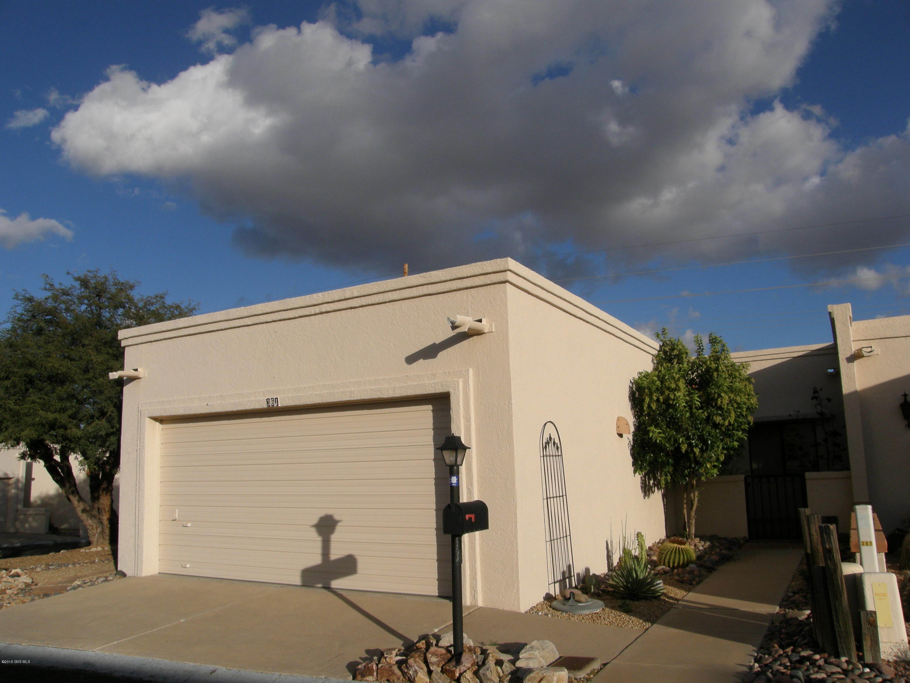 Great townhouse with front courtyard on large corner lot with lots of privacy! This 2 bedroom is bright and spacious with high ceilings, skylights, decorator fans, a gas beehive fireplace and unique custom tile floors throughout. You'll love the architectural features and windows that bring in the natural light. Big closet pantry in the kitchen. Freshly painted interior. Large 2 car garage has cabinets along north wall for storage. The enclosed extended back patio will be where you spend lots of time watching the quail, sipping your morning coffee and entertaining friends. Put this on your must-see list!