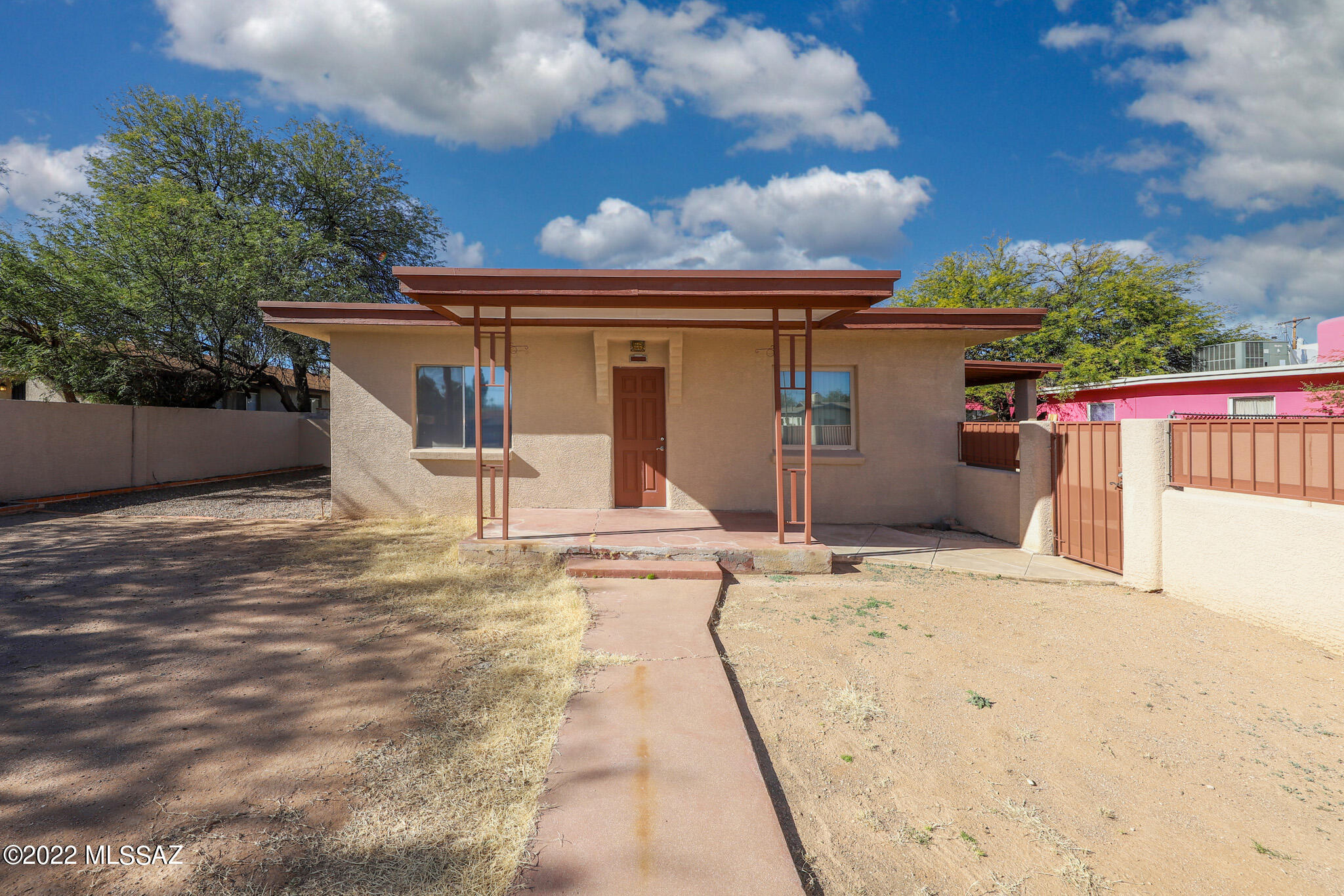 Spectacular 2 bedroom home, well maintained & conveniently located in the heart of Tucson! This property has some of the most AMAZING features including: Detached EXTRA LARGE, 30x30, 2-car garage with an attached 18x18 electrically powered workshop. Not to mention a drive-through carport! Separate double gate for RV space WITH electric outlet! This home is perfect for anyone who would love extensive space for projects, parking, etc. The property is enclosed with a block wall and security gates for privacy. Inside, the home consists of a separate dining room, new paint interior and exterior, new carpet and ceramic tile. More features-Concrete drive from gate to garage, Large rear covered paved patio with ceiling fan and power for a spa. Newly renovated Ramada with gate to a garden area. The large garage could be converted into a separate living space, for an added guest house!! RV hookups allow for traveling guests if you don't have your own RV!