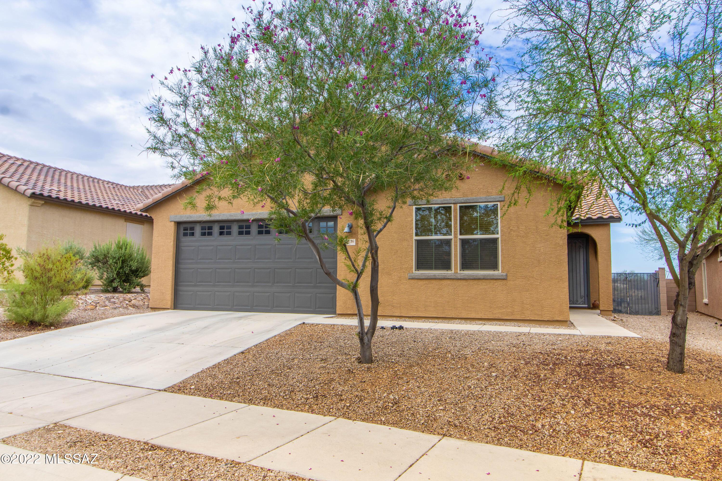 RANGE PRICING - seller will accept and/or counter offers between $485k-$495k. Lovely Energy Efficient 3 bedroom, 2 bathroom home with a den that can easily be enclosed for a 4thbedroom. Builder Upgrades throughout, executive height cabinetry, granite countertops in Kitchen. Seller has added custom wrought iron security door and gate, bathroom showers have been remodeled, newer carpet in front bedrooms, interior paint, beautifully finished epoxy garage floor, and added ceiling rack for extra storage, 2 Nest Thermostats, installed alarm system with an indoor camera and Ring doorbell. The backyard is perfect for entertaining, you'll enjoy a Pebble Tech Pool with waterfall, lagoon, umbrella sleeve for shade and covered patio with an amazing desert view! Come take a look today!