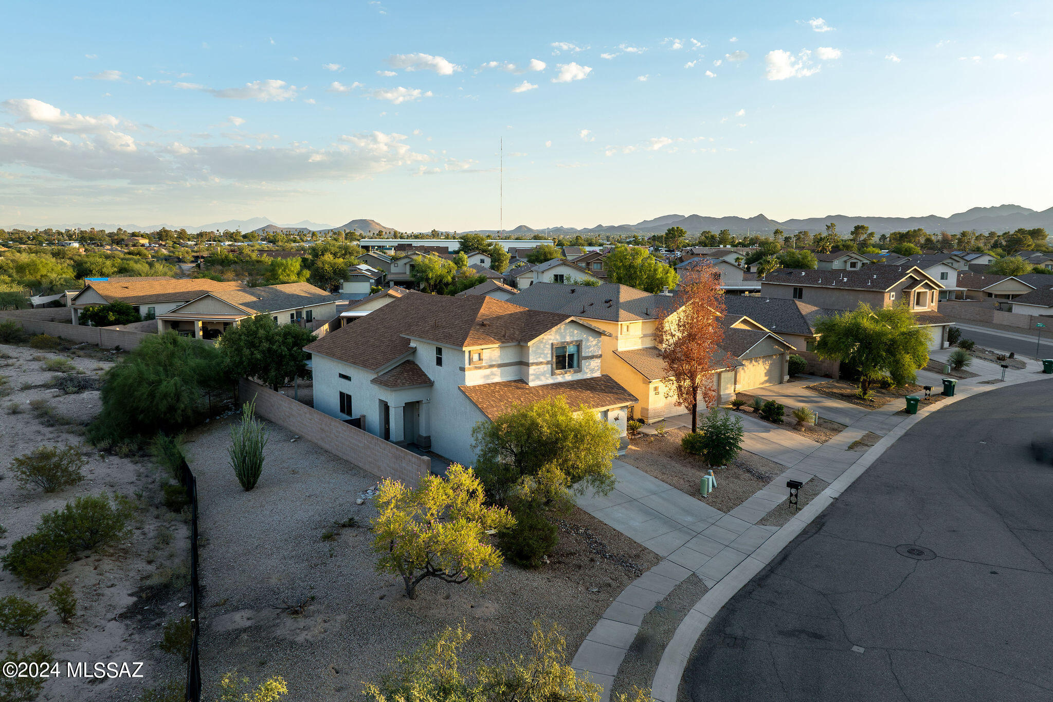 This home has it all! Prime location on the corner of a cul-de-sac street. Lots of privacy and incredible mountain views! Stunning wood plank tiled floors downstairs with a soaring ceiling and decorative lighting. Kitchen has tons of cabinetry, stainless steel appliances, including above range microwave, newer sink and faucet, laundry room off kitchen has extra room for a second refrigerator or freezer! Updates in the last 2-3 years include: water heater, new carpet, luxury vinyl flooring in bathroom, bathroom sinks & faucets, cabinet hardware, door handles, repainted and installed recessed lighting in garage and finished the walls with texture & paint. 90% of roof is a new shingled roof! Ceiling fans throughout, pre-plumbed for water softener and powder bath downstairs for guests. Spacious primary bedroom has room for sitting area, bathroom features double sinks and a walk in closet!
Backyard is nicely landscaped with low care mature trees and shrubs, covered patio the full length of the home, flagstone walkways and an extended gathering area!
Near shopping, restaurants, parks and the Rillito bike path!