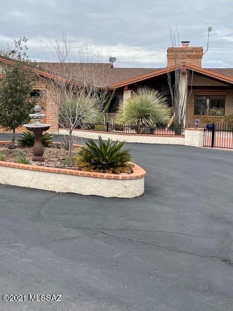Settle into this serene and tranquil community. This burnt adobe ranch style home include a 2 bedroom guest house. An equestrians dream on 2.59 acres with custom barn (built by Mark Stewart), hay shed, arena with custom ground composite, custom stables, wash bay & turnout. Close to wash to ride your horses. Gated community in the popular Powder Horn Estates, NE Tucson, Tanque Verde Valley. Main house offers 4 bedrooms, 3 baths, updated primary bathroom, 20x40 pool. Guest house offers open concept design with newer 5 ton Tran HVAC system.