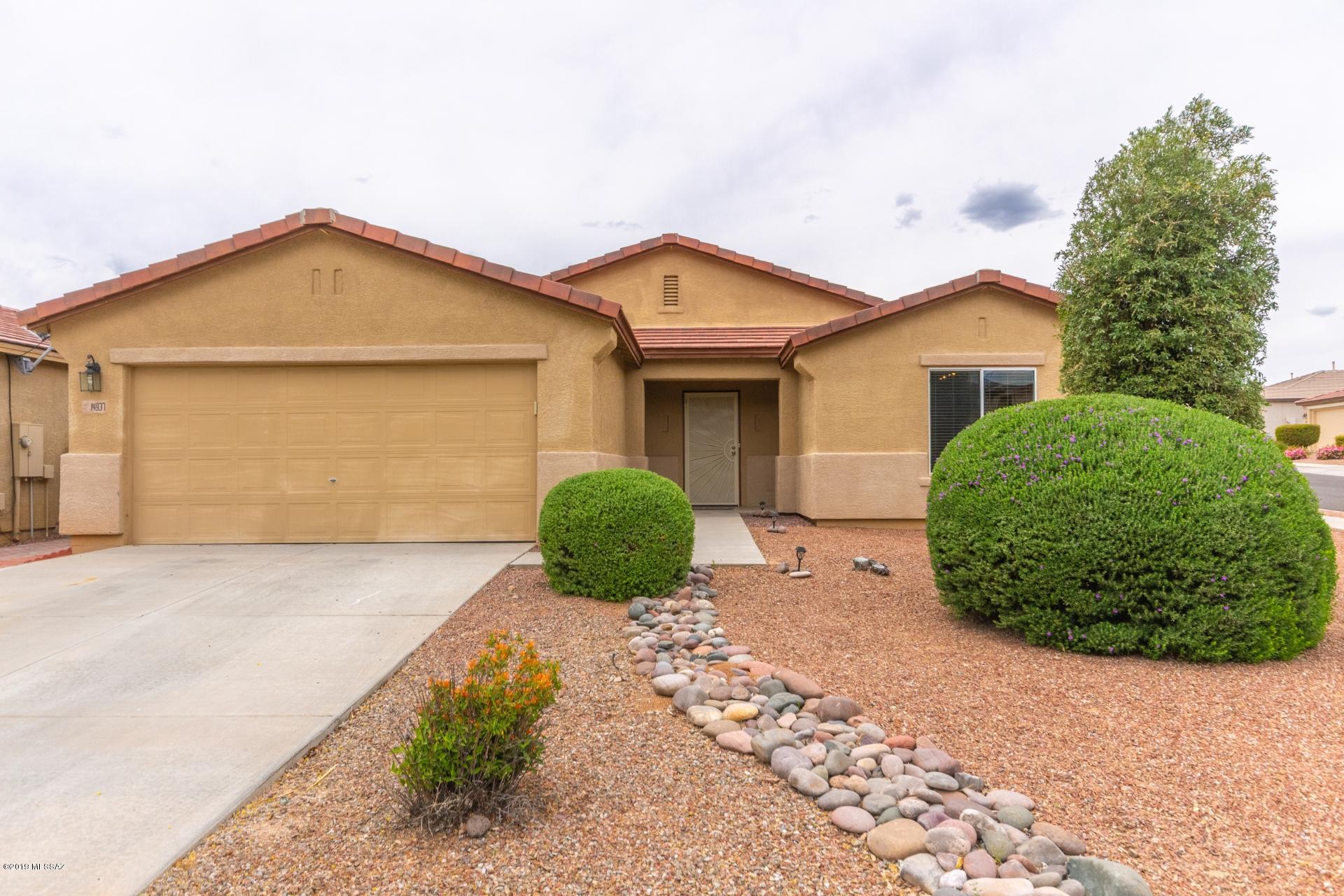 This beautiful cared for home in a popular NW community (Black Horse Ranch) boosts features including 3 bedrooms plus large den, huge great room floor plan, eat in kitchen, breakfast bar, granite countertops, custom  20x20 tile with tile base, nice vanity cabinets in bathrooms with granite counter tops and  brushed nickel light fixtures, several ceiling fans , roomy walk-in closet in master bedroom, large nicely landscaped backyard, dual paned windows. Great view of the Catalina mountains. The neighborhood park is just two blocks away. Move in ready