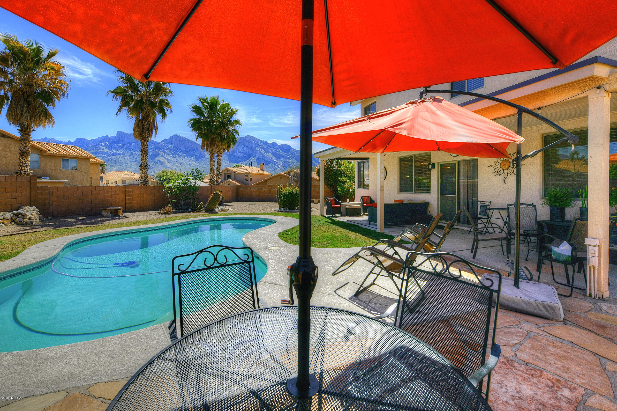 Stunning Catalina Mountain views from this beautifully maintained home in Vista Del Oro Estates.  One of the larger lots in the community situated on the edge of a quiet cul-se-sac. Conveniently located to Riverfront Park, shopping, restaurants, and schools. All new within the last three years include new dual HVAC units, new water heater, new carpet, new pool pump, designer interior lighting fixtures, new granite in kitchen and new window coverings. You will enjoy the sparkling pool in the outside oasis. Leased solar with approximately 18 years remaining.