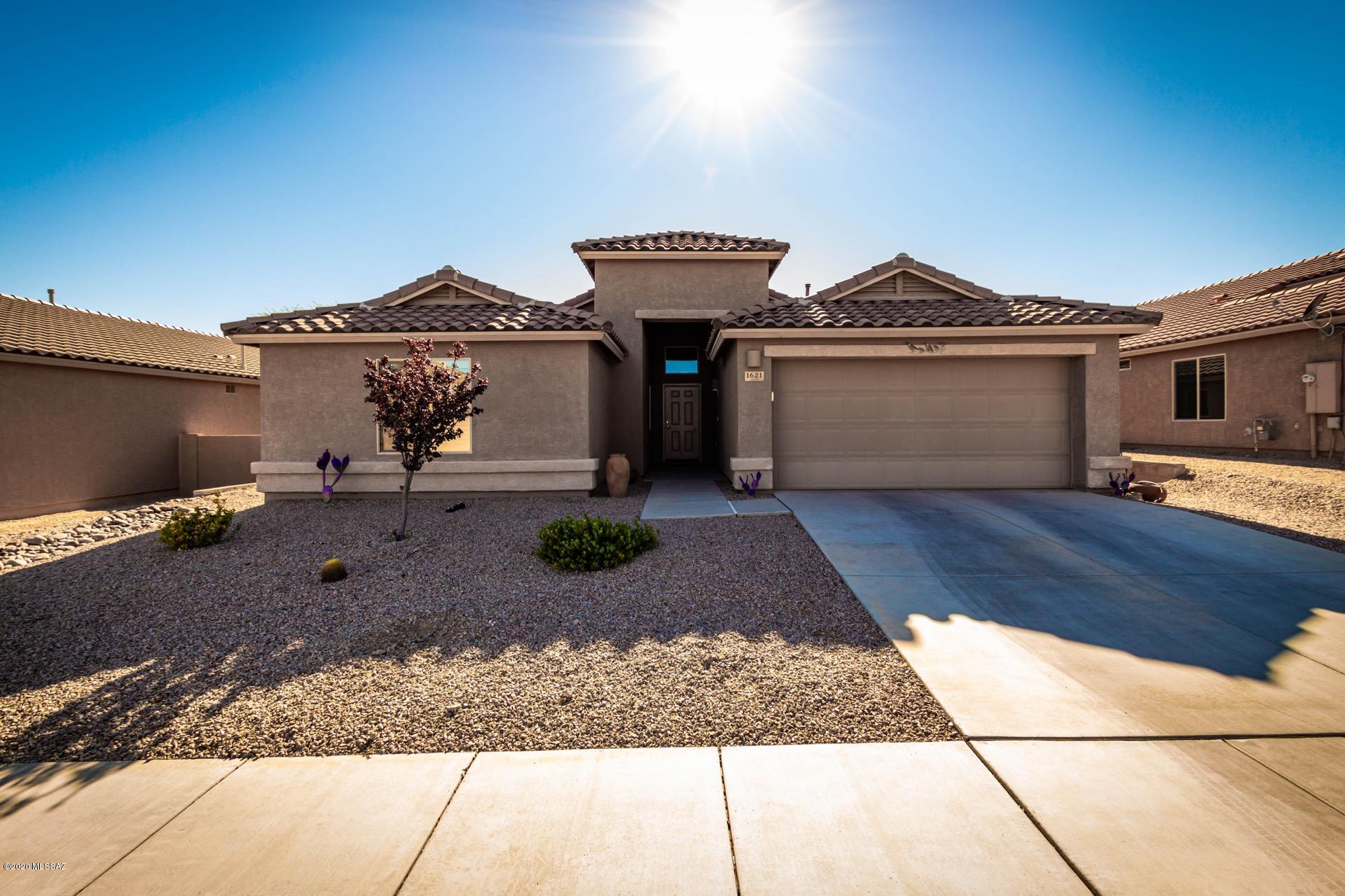 Gorgeous Home in the desirable 55+ Community of Colonia De Los Alamos.  Spacious, inviting and open 2 bedroom 2 bath floor plan, soaring ceilings, beautiful tiled floors, soothing palette, plantation shutters/window blinds, & patio access from great room. Stunning kitchen features a center island, granite counters with plenty of counter space available to cook or bake to your hearts' content, SS appliances, pantry, & handsome dark wood cabinets w/ crown moulding. Perfect home for entertaining. 2 Generous sized bedrooms, plush carpet, ample closets, interior laundry room, & 2 pristine baths. Large den & formal dining room.  Enjoy the low care landscaped backyard with lemon, lime and orange trees, and enjoy entertaining and breathtaking Santa Rita mountain views from your covered patio. Clos to Shopping & more. This wonderful home is ready for you to enjoy!