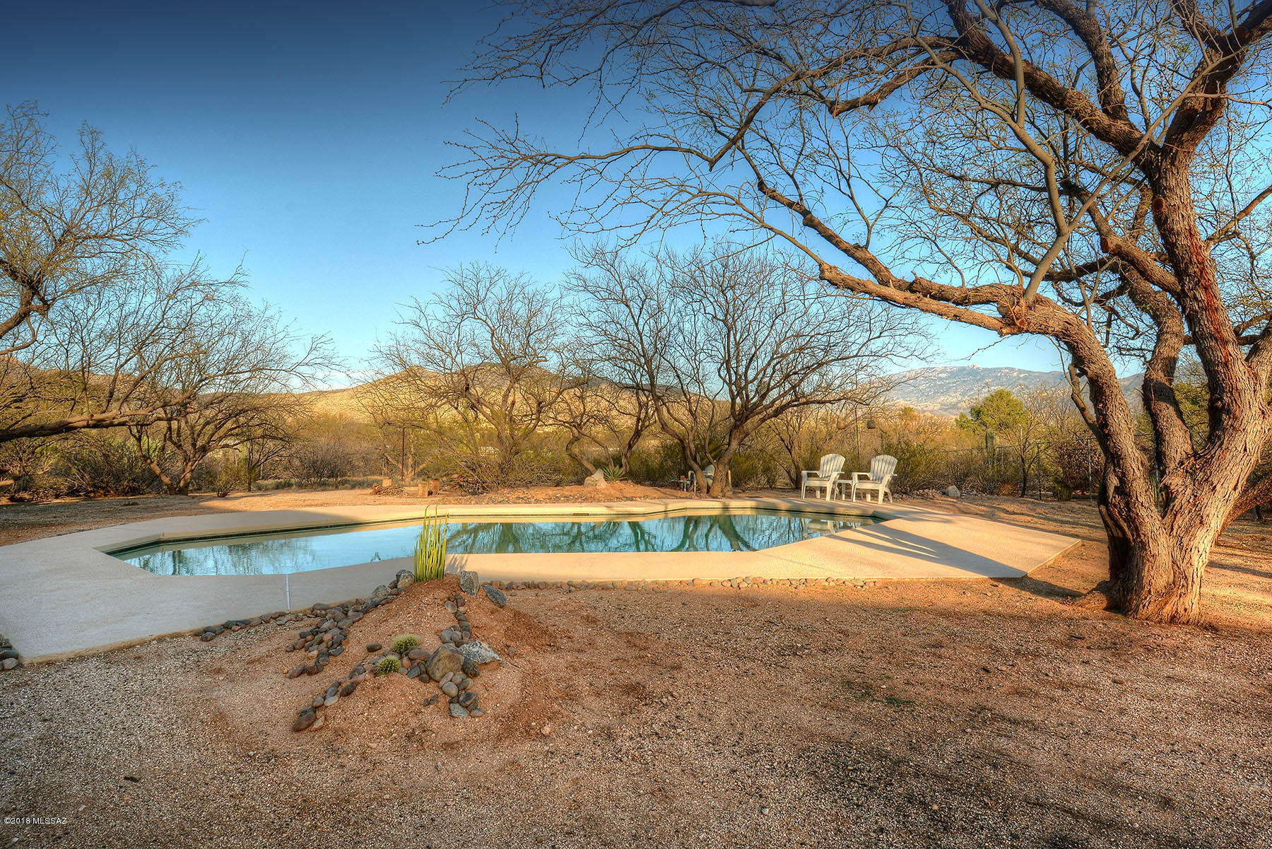 Seller will accept or counter offers between $350K-$375K. Enjoy the mountain views from your huge backyard on .99ac. Remodeled kitchen with beautiful cabinetry, soft close drawers, porcelain tile countertops, stone and ceramic tile backsplash, huge side by side refrigerators & new stove & dishwasher in the last 6 months. Large master suite with 2 closets & bath with travertine tile surround shower & a beautifully restored vanity with granite top and dual copper sinks. This 2,593sf home has 3BD, 2BA with 3 family areas. The family room off the kitchen, the cozy wood burning fireplace room & the large living room w/ dining area. Fully fenced backyard with a beautiful pool, firepit & mountain views. Oversized detached 2 car garage with a pass through garage door. No HOA & horses allowed