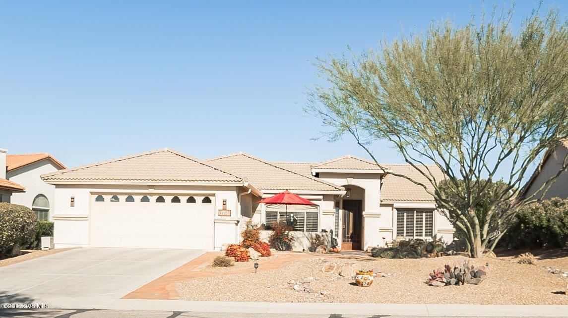 Mediterranean roof lines combined with beautiful desert landscaping lead you through your cozy courtyard to a tall pillared front door alcove. Vaulted ceilings add spatial dimension to the living room with its warm gas log fireplace surrounded by numerous art and media niches, plantation shutters. You will fall in love with the unique custom painting throughout the home done by a local artist using faux finishes. An arched passageway with decorative pendant lighting frame the spacious kitchen with center island, black appliances, elegant engineered stone counter tops contrasting a terra cotta color theme. Enjoy casual meals in the spacious kitchen nook with its expansive front facing views or a more intimate setting in the living room's corner dining area. The den's extensive use  of cabinetry compliments the workstation desk with backyard view windows. The peaceful master bedroom is complete with a huge California closet arrangement and bath with executive height vanity with dual sinks. An exceptional outdoor patio with a full length covered patio, aluminum Ramada, and an outdoor kitchen featuring a professional grade grill, stainless refrigerator, and an attractive built-in serving bar. You will have lots of privacy as this home is tucked cleverly between and #1 and #2 holes of the Coyote Course behind natural desert plantings .
