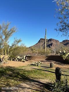 Imagine what living in the heart of the desert would look like; Majestic mountain views, abundant wildlife, sunsets, peaceful, stars for miles. That is what this home has to offer. Perfectly situated in the Sonoran desert with 4.13 acres of privacy. Enjoy the outdoors on the wrap around patio, or out in the desert with your own fire pit watching the falling stars fall around you. This custom home boasts extreme energy efficiency! All solar w/traditional backups with radiant floor heat. Open spacious great room with wonderful fireplace. Zoned, radiant, flagstone floor (4 thermostats thru-out.) Cozy breakfast nook overlooking Panther Peak. Extra large laundry with enormous storage! Extra room can be used as an office or massive pantry. Off the beaten path, but not too far from town (15 minutes). Come enjoy this wonderful piece of property your Buyers will not be disappointed.
