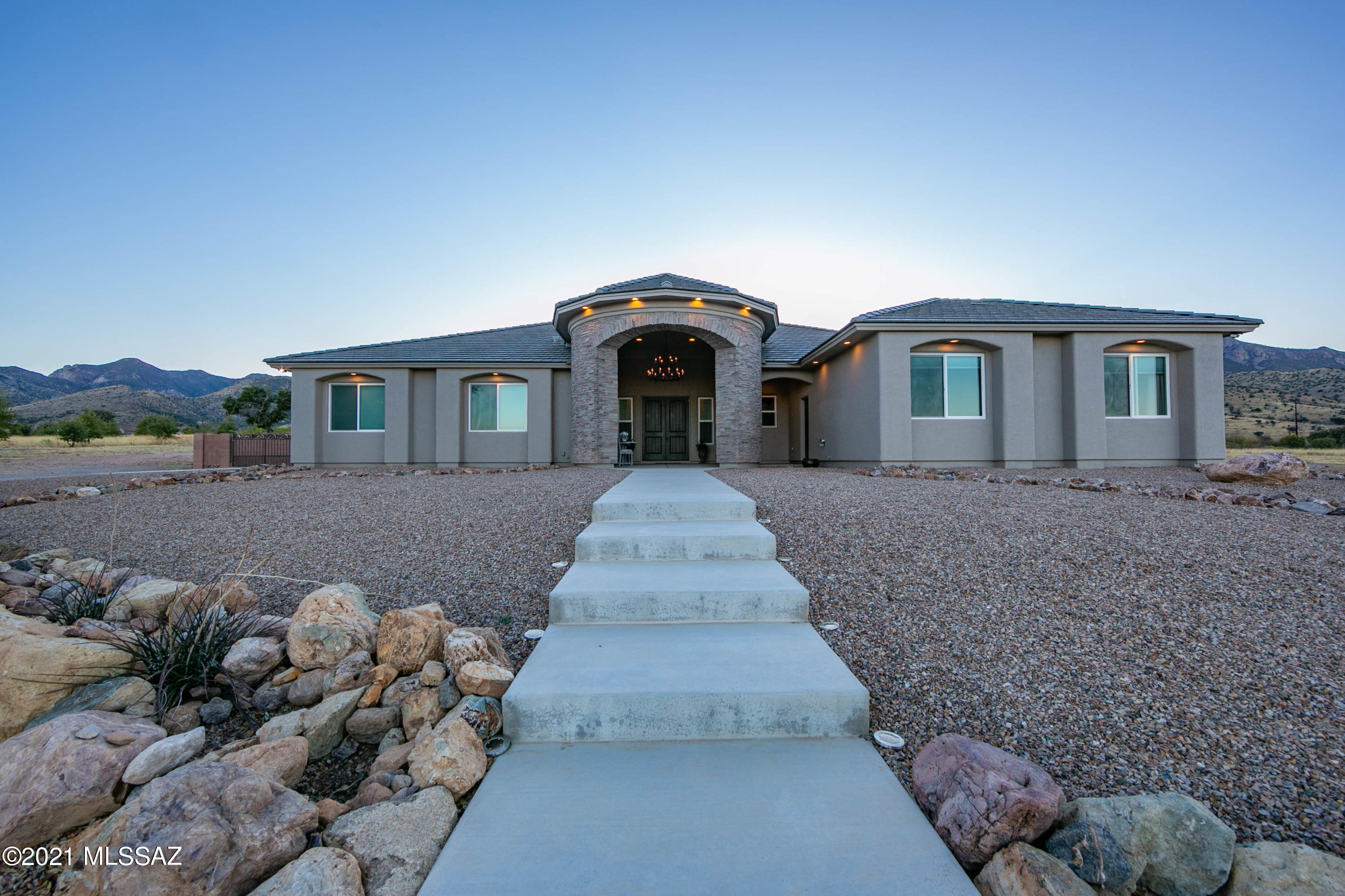 Stunning, panoramic views will captivate you at this truly remarkable custom home. Built with refined quality, this absolutely gorgeous residence will appeal to the most discerning buyer. The owner designed this home with complete care, thought, and love and it truly shows throughout. You will be greeted by a circular, turret-like entryway that provides covering and beautiful exterior stone work. Entering into the home a lovely foyer welcomes you. Beautiful tile throughout, and carpets in the bedrooms. Extra large great room concept is ideal for gatherings and entertainment. The chef's dream kitchen features exposed and reinforced mesquite wood shelving, high quality granite slab, stainless appliances, and custom backsplash all the way to the ceiling.