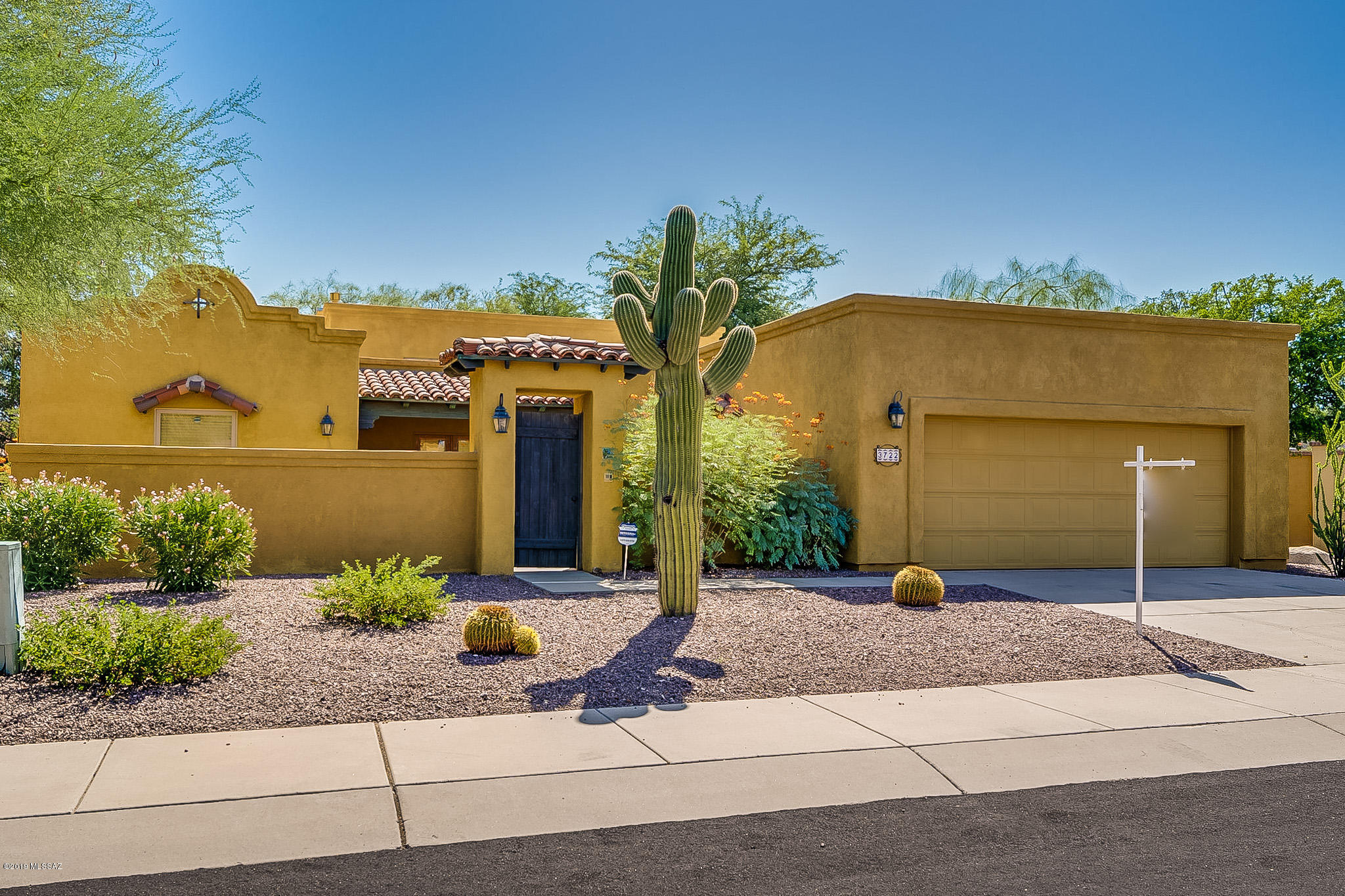 RARE FIND! Luxury abounds in this 4 bedroom home in this small gated community of only 18 homes. An original model home, there are many upgrades throughout which includes scored concrete floors, soaring ceilings with wood beams, gas fireplace, French doors that lead to the charming front courtyard & others that lead to the rear yard. The kitchen has 42'' cabinets, S/S appliances, center isle, granite tile counters & plant box window. MBR with large bath w/2 walk-in closets, jetted tub & separate shower. Double vanities in both baths. Double closets in bedrooms. Windows replaced in 2017.  The over-sized laundry room will make you want to do laundry. Rear yard has large covered patio w/ceiling fan & recessed lights and turf in yard. Home has 2x6 construction. You will love how conveniently You will love how conveniently located this lovely community is with the easy access to restaurants, shopping, U of A and more. Schedule your showing today before you miss out on this beauty.