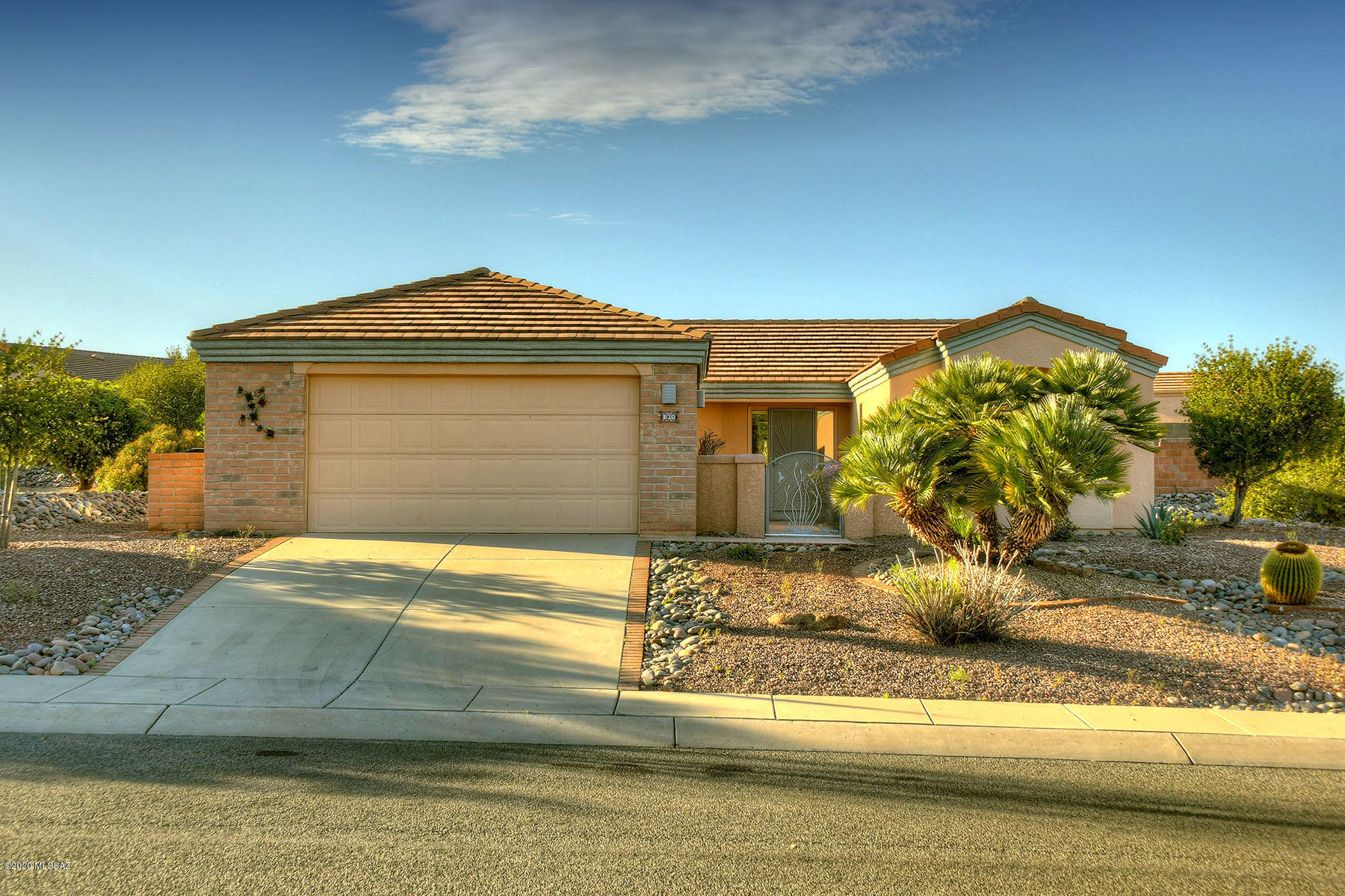 If you love to entertain and like creative spaces and interesting architecture in your home, you will love this beautiful house!  There is maximum curb appeal with the red tile roof and large, bricked front courtyard.  Have your morning coffee here where the Santa Rita mountains are your view!  Inside, the living and entertaining space options are endless.  A large front living area has a dining area adjacent, perfect for large gatherings.  If you like a more cozy feel when not entertaining, use the breakfast bar and nook for casual meals.  The family room is set up for movie night, with the big TV screen hanging over the glowing fireplace.  The kitchen is open to the family room and is as functional as it is pretty.  Fresh white cabinets give it a modern feel and are accented with dark granite counters.  The formal living area opens onto the covered patio allowing an indoor/outdoor flow for entertaining large groups.  The patio is a peaceful and inviting outdoor space, with a curved pony wall, lush landscaping and pergola cover.  Your master suite is spacious and bright and features a dual vanity, walk in shower and plenty of closet space.  A private office, craft room or library in the master offers plenty of quiet and privacy and hides those messy projects.  The different living areas in this home can be adapted to accommodate any lifestyle. Small enough to be a winter retreat, or large enough for full time living, it will be easy to make it your own!