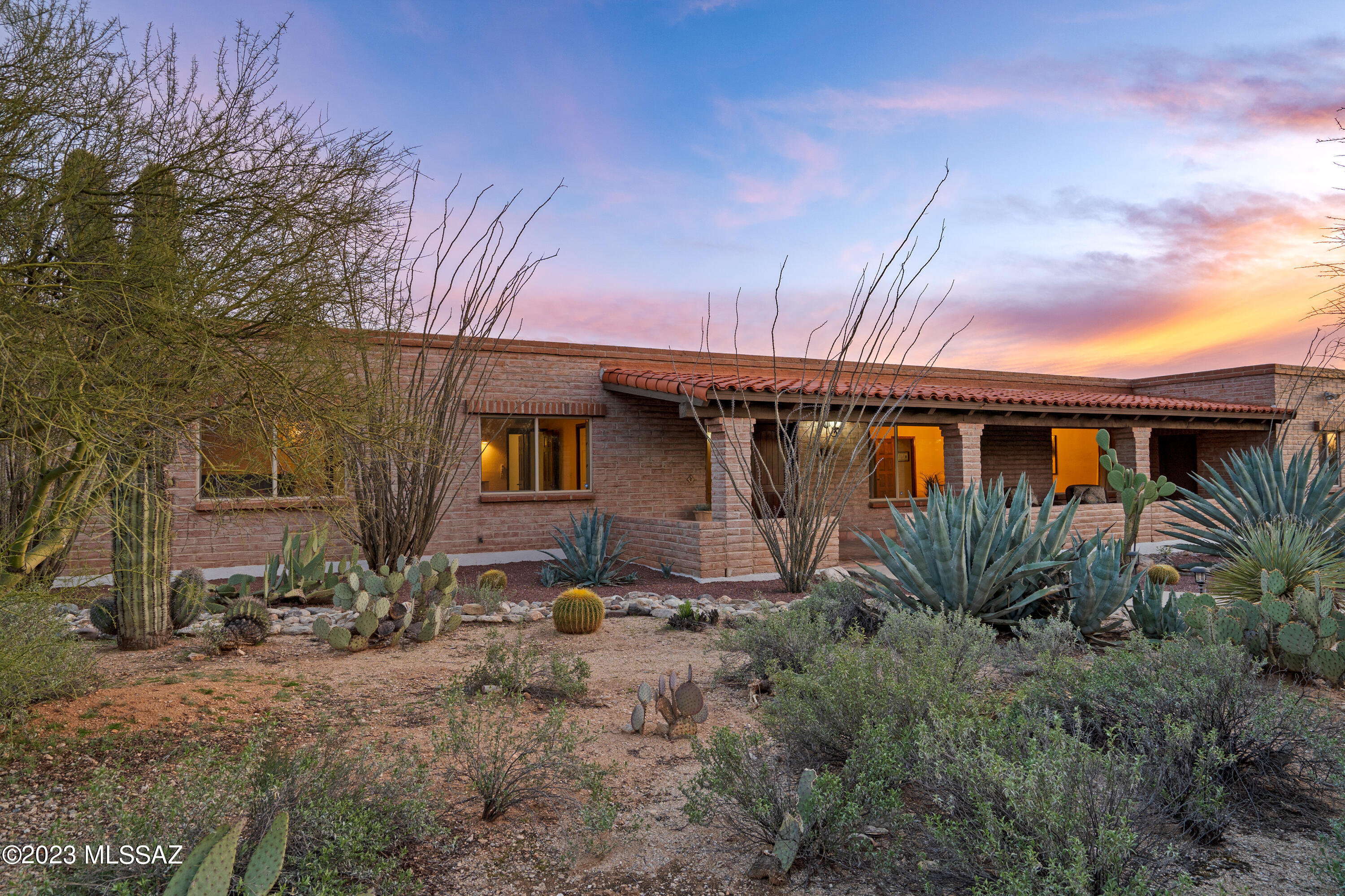 A quintessential Tucson home in District 16! This remarkable property featuring burnt adobe construction exudes Tucson's charm with expansive veranda perfect for watching sunsets and the Catalina Mountains, 2 primary suites each with en suite baths & beehive fireplaces, huge family room with fireplace, wood beamed ceilings, formal living room with large windows, Rogos concrete flooring, kitchen with double ovens. Incredible yard spaces surround the home including an extensive paver patio with pool, ramada, pizza oven, firepit, outdoor fountain, and newer side yard with unparalleled Catalina Mountain views, hot tub, sport court, turf, and natural desert plantings. This home has it all and is located in the perfect north central location of Catalina Foothills Estates. Floor plan available!