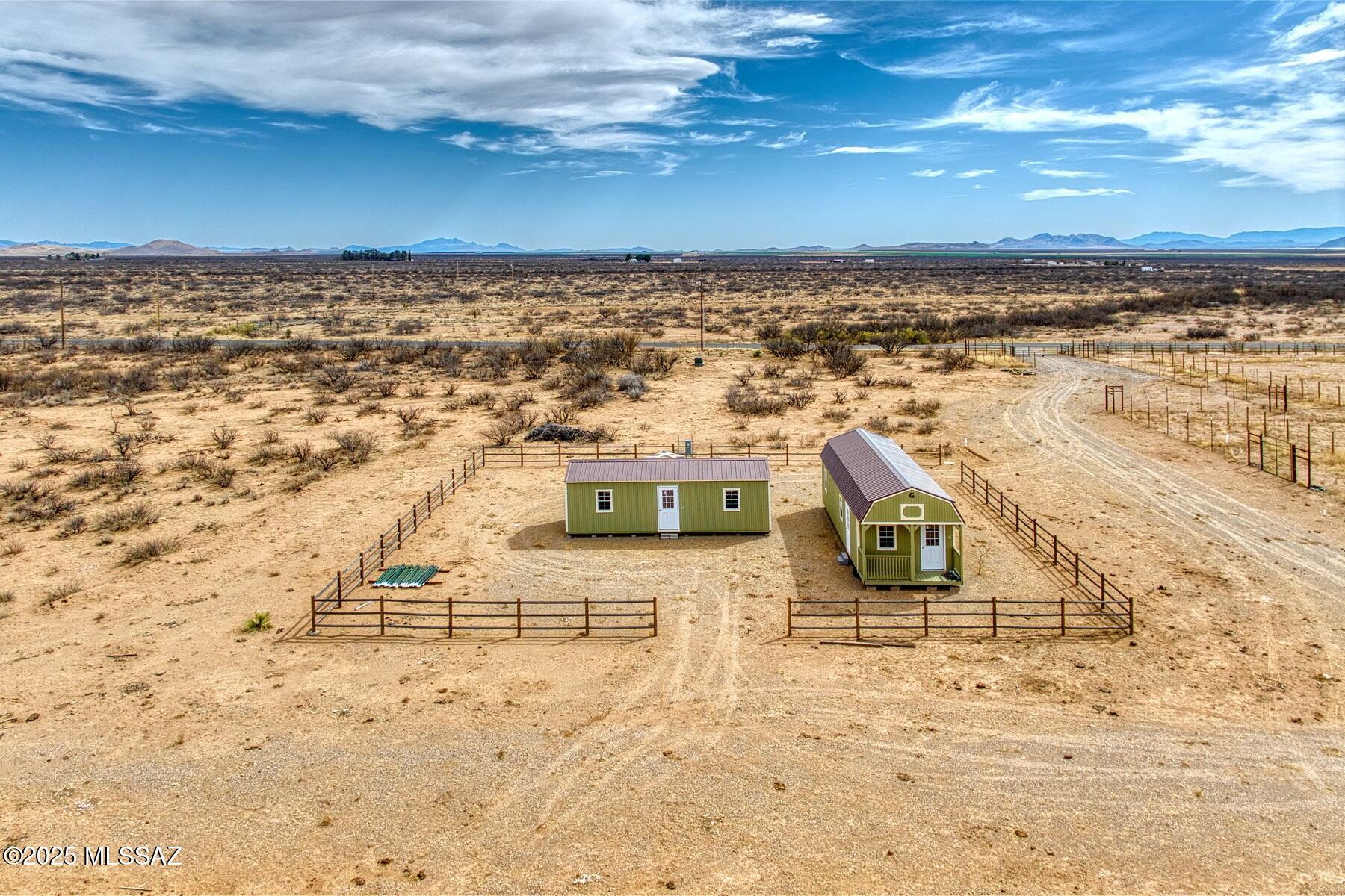 This exceptional 39-acre property, located in the heart of the renowned Willcox wine-growing area, is perfect for those looking to build their Dream Home, create a Homestead, pursue agricultural projects, start a small farm, tap into the growing wine industry, or create a garden, or farming operation, offering endless possibilities for both agricultural ventures and personal projects.
Property Features: 39 acres of flat, usable land, NOT located in a Flood Zone, 2 Cabins/Sheds, A 2,500-gallon water storage tank for hauled water (NO WELL), 200 Amp Electrical Service, o	400-foot AB/Gravel Driveway, 3/4-acre fenced growing area with sturdy field fencing, Zoned RU-4, the coveted zoning for Cochise County that allows for Owner Opt-out Building. See additional remarks for Detailed Features Detailed Property Features:
-Size: 39 acres of flat, usable land, ideal for a variety of agricultural or personal projects. Property is NOT located in a Flood Zone
-Cabins/Sheds:
-14' x 40' Cabin/Shed with an extended loft, offering ample space that can be easily converted for a multitude of uses, including living space, storage, office, or workshop.
-12' x 32' Shed, ideal for additional storage, workspace, or could also be repurposed for a variety of other functions, including a small guesthouse or hobby area.
Both structures are highly versatile and can be adapted to suit your needs.
-Storage Tank: A 2,500-gallon water storage tank for hauled water, ensuring an ample water supply for any use on the property.
-Utilities:
-200 Amp Electrical Service, providing sufficient power for all your needs.
-400-foot AB/Gravel Driveway leading off a paved, County-maintained Road for easy access year-round.
"	Fenced Area: A spacious 3/4-acre fenced area with sturdy field fencing, originally designed for wine grape growth. This fenced area offers the perfect space to start a personal garden, orchard, or farming venture.
-Zoning: Zoned RU-4, the coveted zoning for Cochise County, which allows for the potential of an Owner Opt-Out building, offering you flexibility in the type of structure you can build on the property.
-Mountain Views: Enjoy stunning, panoramic views of the nearby mountains, adding to the serene and peaceful atmosphere of the property.
-Planting Zone: Located in the 8b Planting Zone, ideal for a variety of plants, fruits, and vegetables. Perfect for starting a garden or farm.
-Versatile Land: While this property was previously intended for grape cultivation, the land is versatile and can support a wide range of agricultural uses, including orchards, gardens, livestock, or other crops.
-Prime Wine-Growing Area: Located in the heart of the Willcox Wine Growing Area, this property is perfectly positioned for those interested in pursuing viticulture or expanding into the thriving wine industry. The area is known for its rich soils and favorable climate for growing high-quality wine grapes.