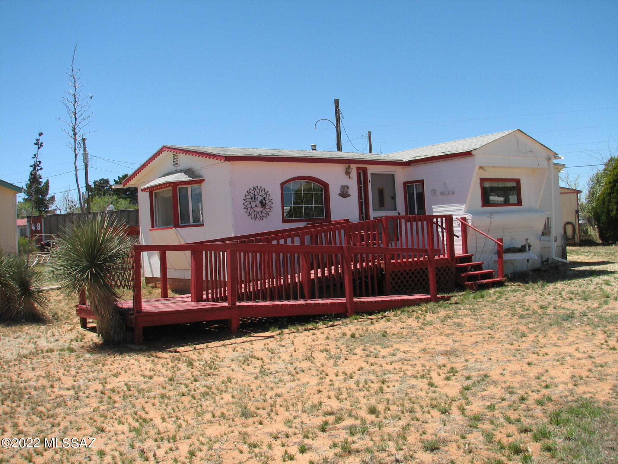 Well cared for mobile home with two site built additions, one front and one rear.  Mobile home is a 1959 model and additions are 1996 per assessor.  Spacious, bright and cheery.  Nice kitchen with lots of cabinet space.  Two Detached sheds plus a detached one car garage.  Entire lot is fenced.  Easy care yard with nice desert plantings.   All personal property now existing on the premises is included in the price and will convey at close of escrow. Property being sold as is, cash only.