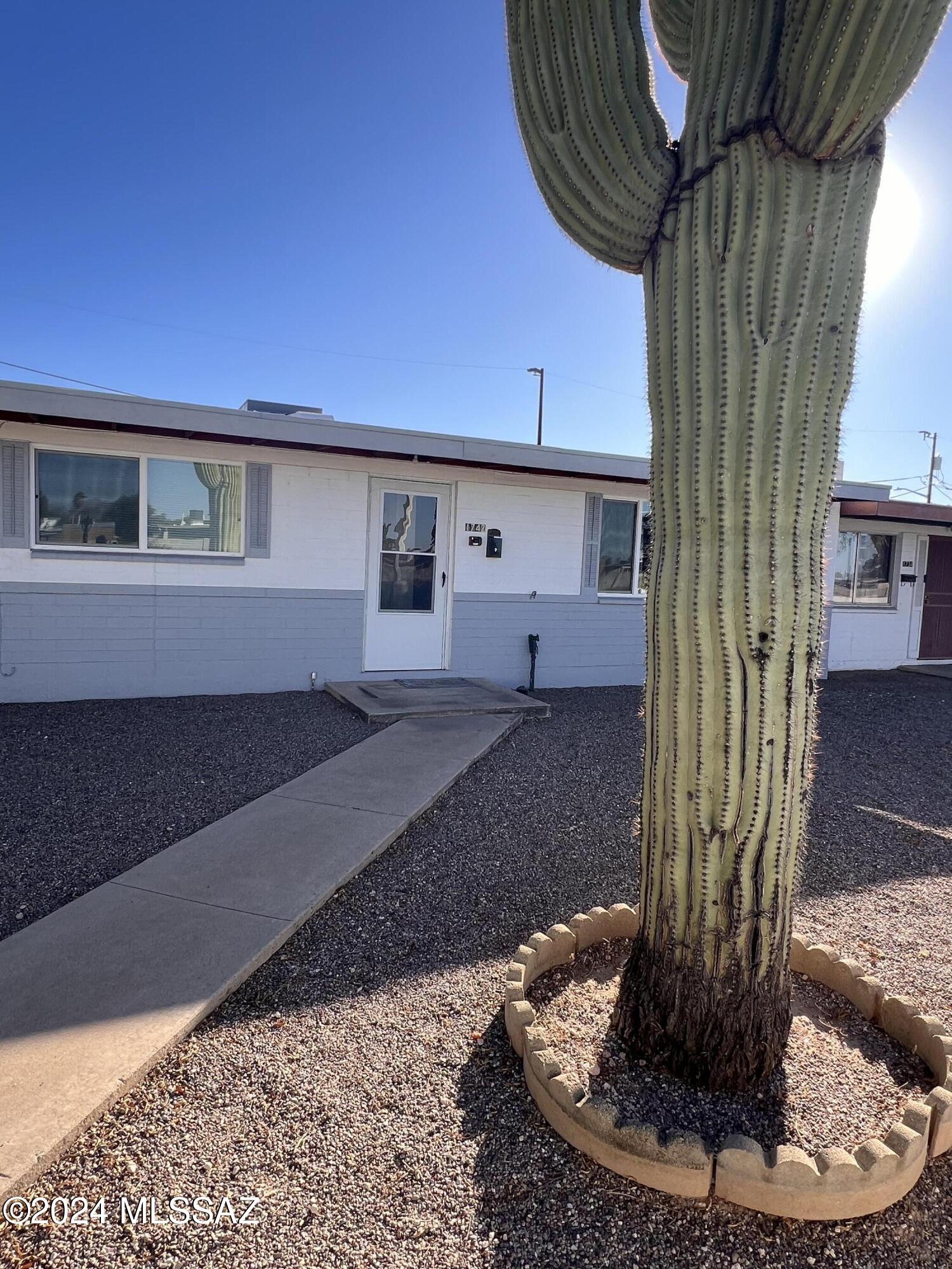 This spacious and well-maintained townhome has ceramic flooring throughout the entire house and has recently been updated and upgraded with new dual pane windows in 2024, a new fridge, new water heater, new contemporary vanities in both restrooms and new contemporary light fixtures. The A/C is newer, and the roof was just recoated in 2024. The master bedroom is large and has plenty of open space. The master bath has a roll in shower and grab bars. The kitchen is spacious and open perfect for entertaining with a large living room and an open Arizona room that leads to the back yard. The back yard is easy to maintain with a covered patio, a carport, a storage shed and a storage closet. The exterior features a ramp to gain easy access into the house. The washer & dryer are included.