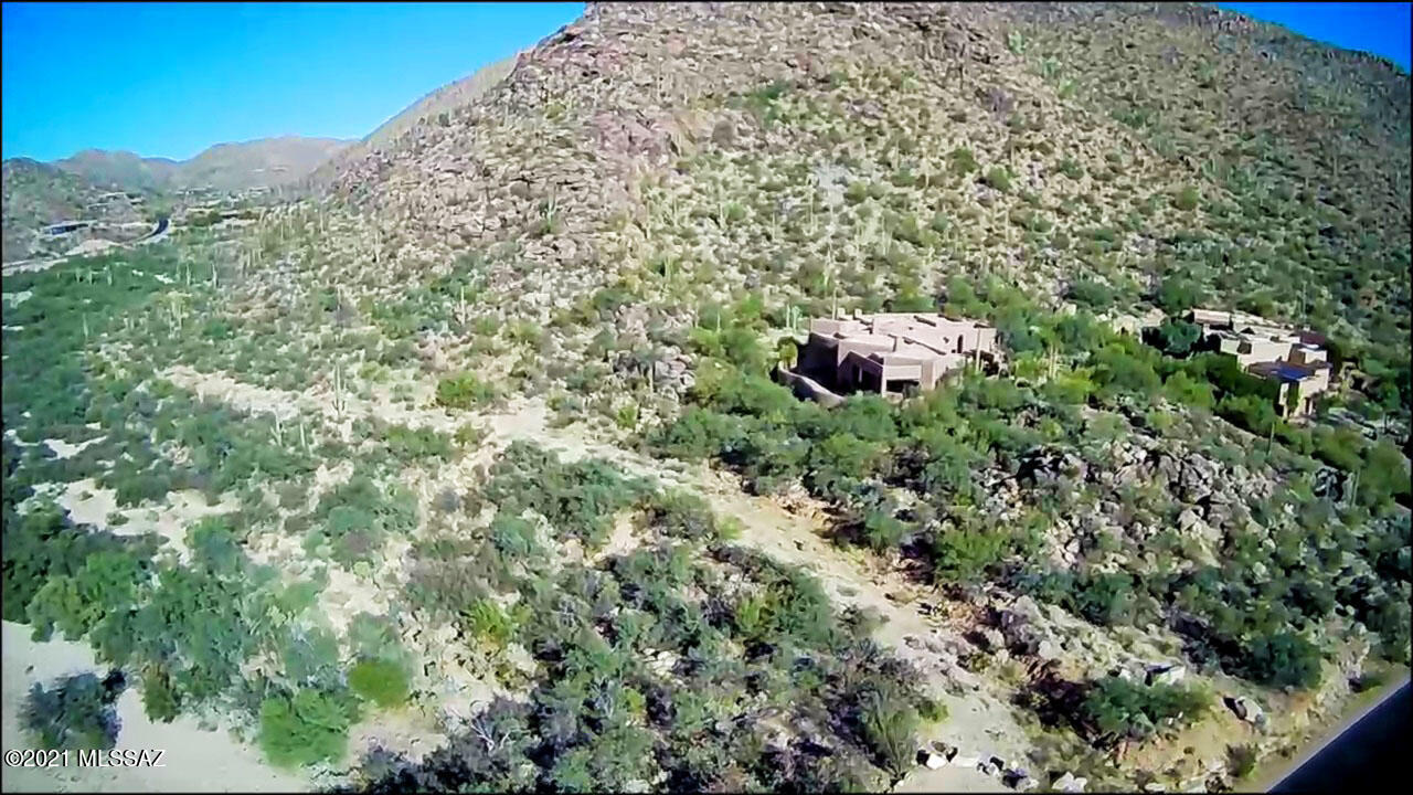This private ''Sanctuary'' Estate lot on over 4 acres is located in Canyon Pass/Dove Mountain, just a short drive from the main entrance gate. You need to walk this lot to appreciate all that it has to offer!

All utilities including sewer are located at the property. This spacious unique property will have a meandering driveway to your private estate.  

The rendering in photo 1 is what the home could look like viewing the incredible saguaro laden rock outcroppings with sheets of glass with stunning mountain and canyon views. The wash adjacent to the property provides a sense of privacy   from the current and future residents.

Join Escalante's, Club 63 (This includes the Ritz-Dove Mountain club) or ICON for all your golf, sports and entertainment. Please call for a private showing!