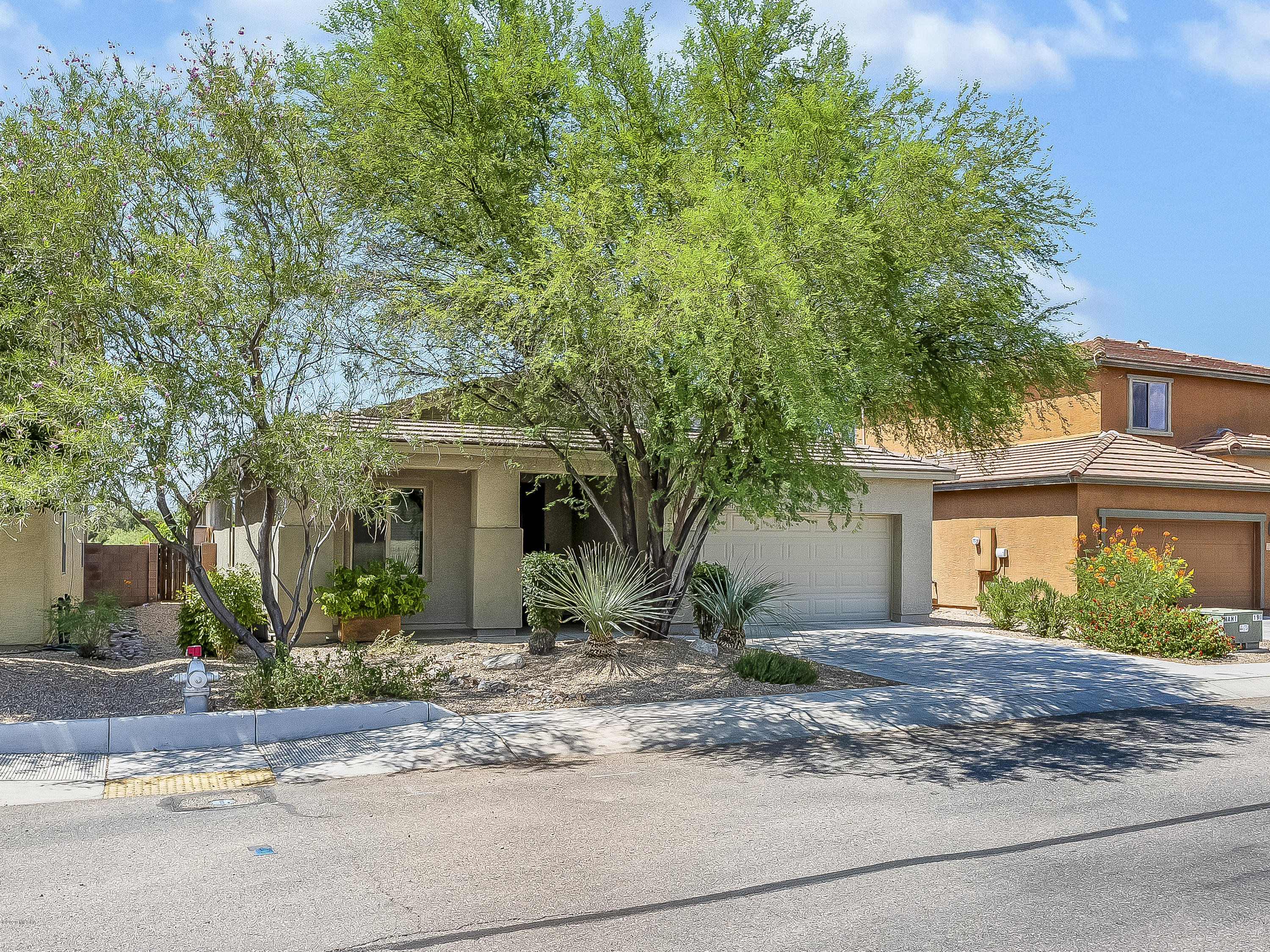 Beautiful Gem 3 bed/2 bath home located in highly sought after Madera Highlands. Great room concept with tile flooring throughout the home, modern designer lighting & fans. Home features extended garage, cabinets in laundry, custom closet in owner suite closet, solar panels that are owned, upgraded appliances, large sink. Huge backyard with covered patio that you can use for additional entertainment space or relax to complete the backyard with mature trees & beautiful desert plants. Home backs up to open space w/no one behind you. The Madera Highlands community offers amenities such as pools, park, tennis court, basketball courts. Very convenient to shopping and only 20 minutes to Tucson!