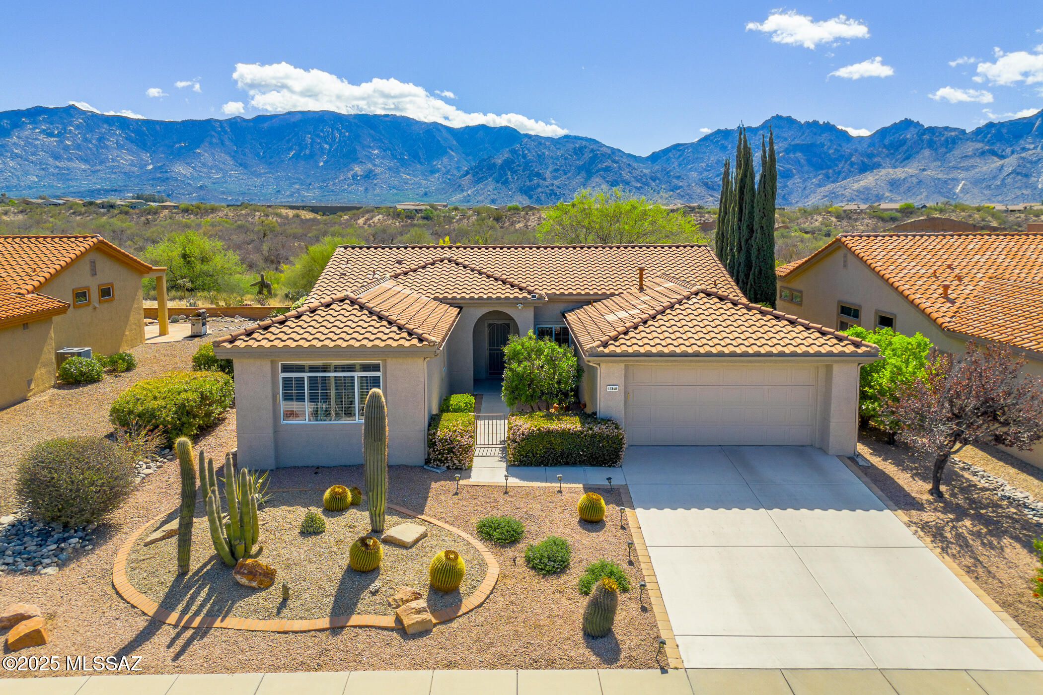 You will love this beautiful Crescent model home, highlighted by its stunning, panoramic views of the Catalina Mountains and its desirable lot location. Located in the highly coveted community of Sun City Oro Valley, this home boasts two bedrooms, 2.5 bathrooms, an open floor plan w/gas fireplace, plus a small office with a built-in desk & cabinets. This home offers a bright & updated kitchen with gorgeous granite countertops, breakfast bar, Knotty Alder cabinets, dining area and adjoining great room with fabulous green space and mountain views. Wake up to lovely mountain views from the spacious owner's suite which boasts a bay window, a walk-in closet, back patio access door and an en-suite bathroom with double vanity and walk-in shower. The 2nd Primary suite features a desk & shelving, a walk-in closet and en-suite bath with shower/tub combo. The additional half bath is conveniently located for guests. Enjoy wonderful outdoor living on the extended patio spaces as you take in the expansive views of the Catalina Mountains and natural desert. This home has a fully fenced backyard, roof underlayment has been replaced, 2017 HVAC and the exterior has been freshly painted. Don't miss your opportunity to own this move-in ready, big view home. Begin your active adult lifestyle today!