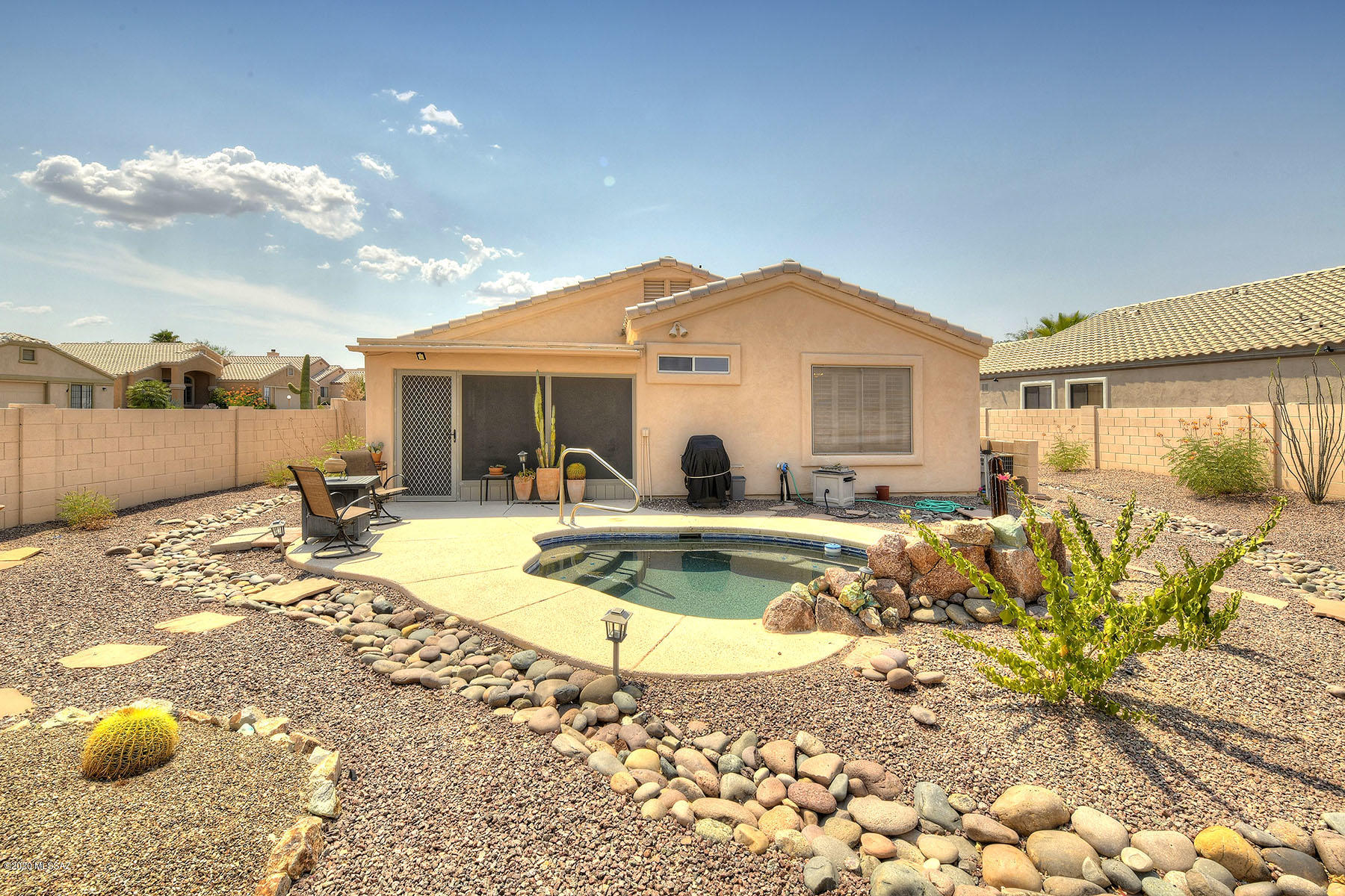 Fantastic 3BD/2ba 3 Car garage home located on a corner lot in the desirable adult community of Desert Creek. You will enjoy an open floor plan w/ vaulted ceilings & ceramic tile flooring throughout except bedrooms.  Spacious living room opens to kitchen w/ breakfast bar, plenty of cabinetry, counter space, island & breakfast nook. Master suite boasts walk-in closet & garden tub in bathroom. Large laundry room adds extra storage. Electronic security shutters on front windows, solar screens &  plantation shutters add privacy & comfort.  Enjoy the mountain views in the heated spool w/water feature from the large backyard. Screened in porch allows year round outdoor dining. Built-in cabinets in the 3 car garage. Beautiful & comfortable furnishings included. Just bring your toothbrush!