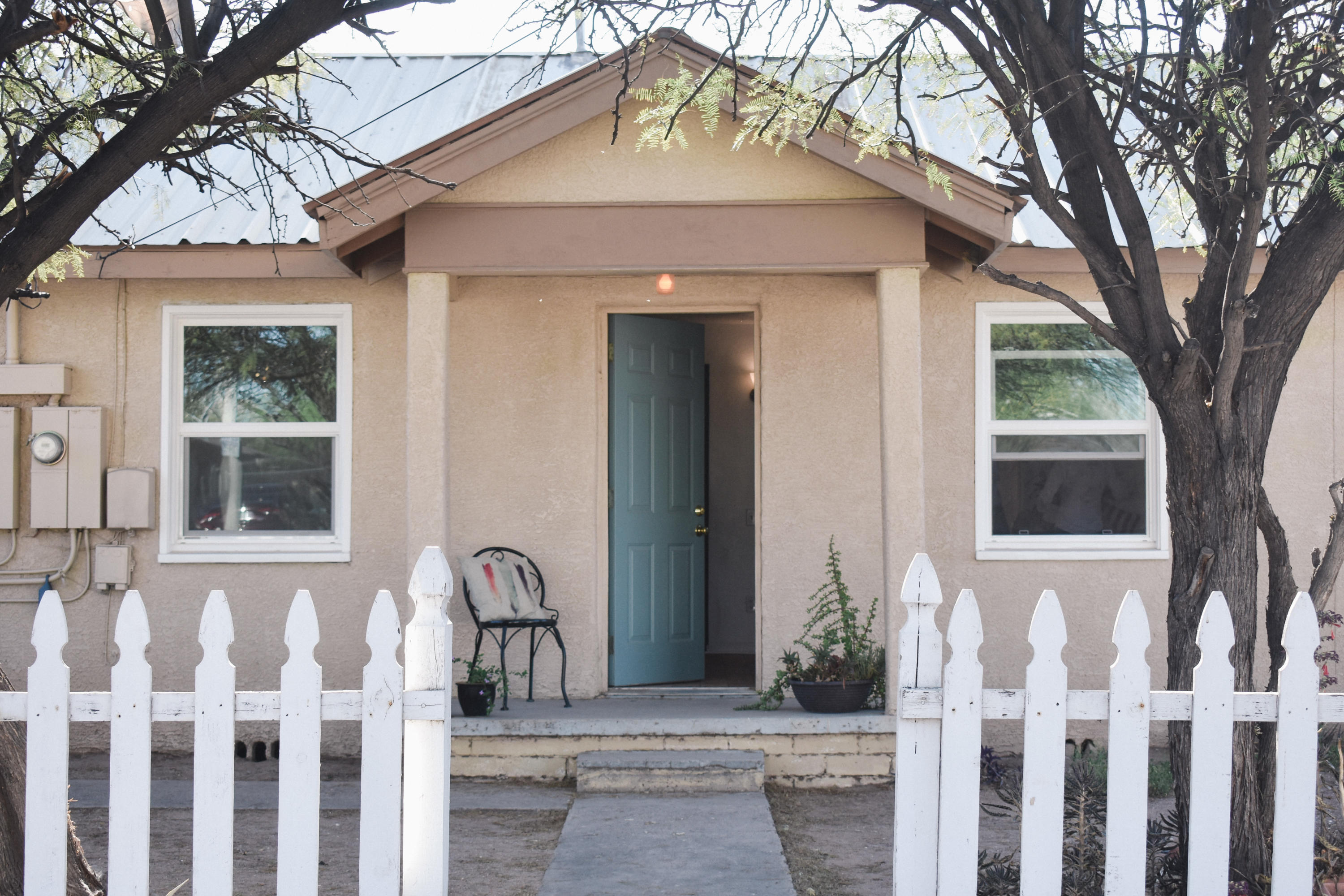 This unique property offers 2 homes on one lot, with endless opportunities. This charming, historic home is located in an up and coming barrio. Close to downtown, the VA hospital, and 5 minutes from A mountain. The main house has a Santa Fe flair with a beehive fireplace, thick adobe walls, and rustic beamed ceiling. The main house has also been renovated with new stucco, an AC unit, electrical upgrades, and fixtures throughout. 

With two houses on this lot, this home could be a super income property!  Live in the front and rent out the back or make it into your art studio or private office.