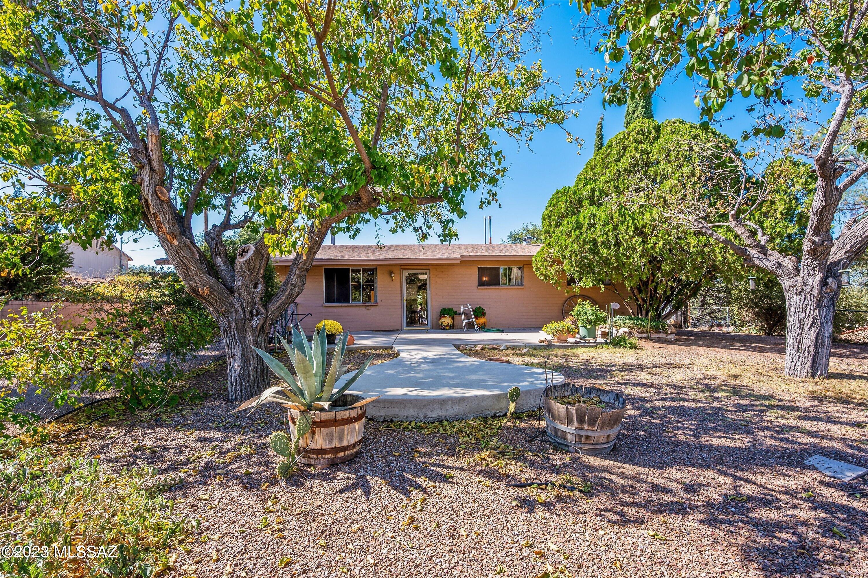 Sweet house on the hill! Exceptional block house with 3 bedrooms and two full baths sitting on a third of an acre in the cool temperatures of Oracle Arizona. Wide open living room and kitchen lead into the cozy Arizona room and out onto the wrap around porch. Spacious master bedroom connects to recently added master bathroom which also includes washer and dryer! Two thing's at once! Additional studio/ work room.
Freestanding, two car garage plus plenty of additional parking space leave's room for toys and storage. 
Fantastic oak and cypress trees give shade and beauty to the hillside property all through the day.
Not many quality house in this price range. All the heavy lifting has been done. Come up and find your next home. No HOA!