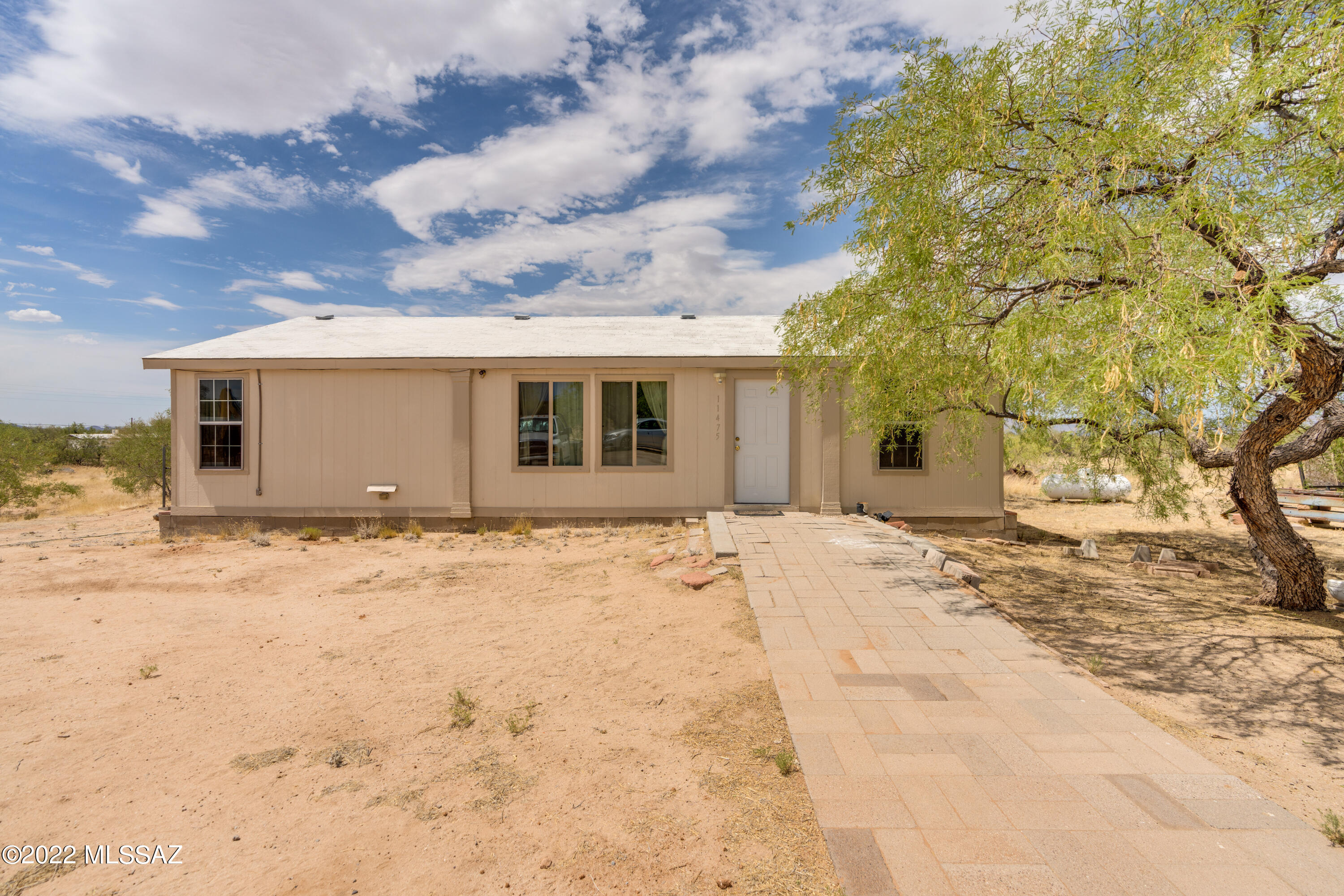 WoW a unique opportunity to own 4.82 acres with a 3/2 bath home, 4 car garage, a salt water pool AND Drumroll please ... 2 additional septic tanks, electric pedstals and  water connections!   Just imagine the possibilities!   

Inside the home:  You find an open and inviting living room, and large kitchen with lots of cabinets.   A split bedroom floor plan.   A soaking tub and separate shower in the primary bath.  Large closet spaces.

4 car garage- create the space you need.  Maybe 2 cars and a large workspace or 3 cars and a motorcycle- the possibilities are endless!   

2 separate septic, electric pedestals, and water connections are on the west side of the property.  

Very refreshing a/c with a10 Ton AC, unit 200 Amp service