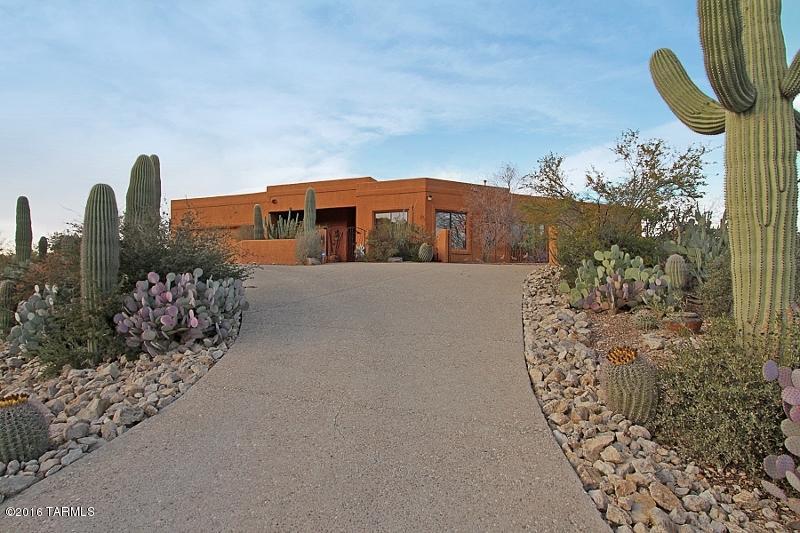 Stunning custom Southwest 'Home Tour Winner' sits atop 1.97 acres surrounded by native desert vegetation and breathtaking Mountain and City views. Open Great Room plan boasts Living Room w/Fireplace, formal Dining Room, Family/Breakfast Room, Office/Den, and gorgeous open Kitchen featuring stone counters, SS appliances, island, breakfast bar, and large pantry. Elegant Master Suite w/cozy FP offers dual walk-in closets, walk-in shower, jetted tub. Built-in entertainment center featured in two rooms plus all bedrooms host full baths. Abundant natural light, thicker walls, high ceilings, archways and skylights accent this luxuriously appointed home ideal for entertaining.  Wonderful rear patio features large flagstone tile and Kiva fireplace. RV parking plus room to add pool and guest house!