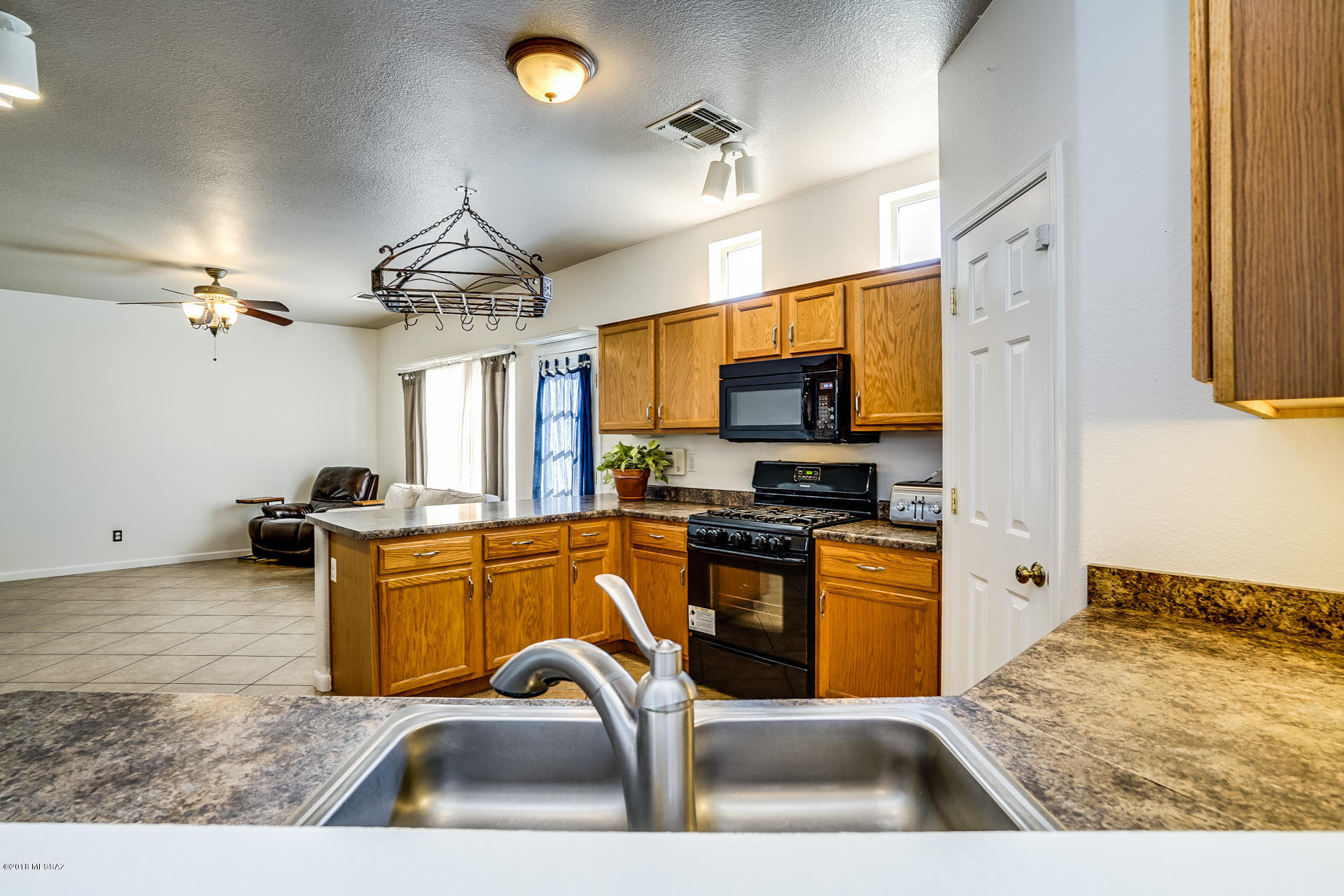 Your lovely new home is nestled in the perfect location of the resort community of Rancho Sahuarita.  Your home will be located a block from the local park and 3 blocks from the lake.  One of the rare prime lots this home is located off a cul-de-sac within an extended driveway and large private backyard.  The backyard is low care with turf and pavers but plenty of room  for flowers or gardens.  We have prepped for your arrival with interior AND exterior paint.  So when would you like your keys?