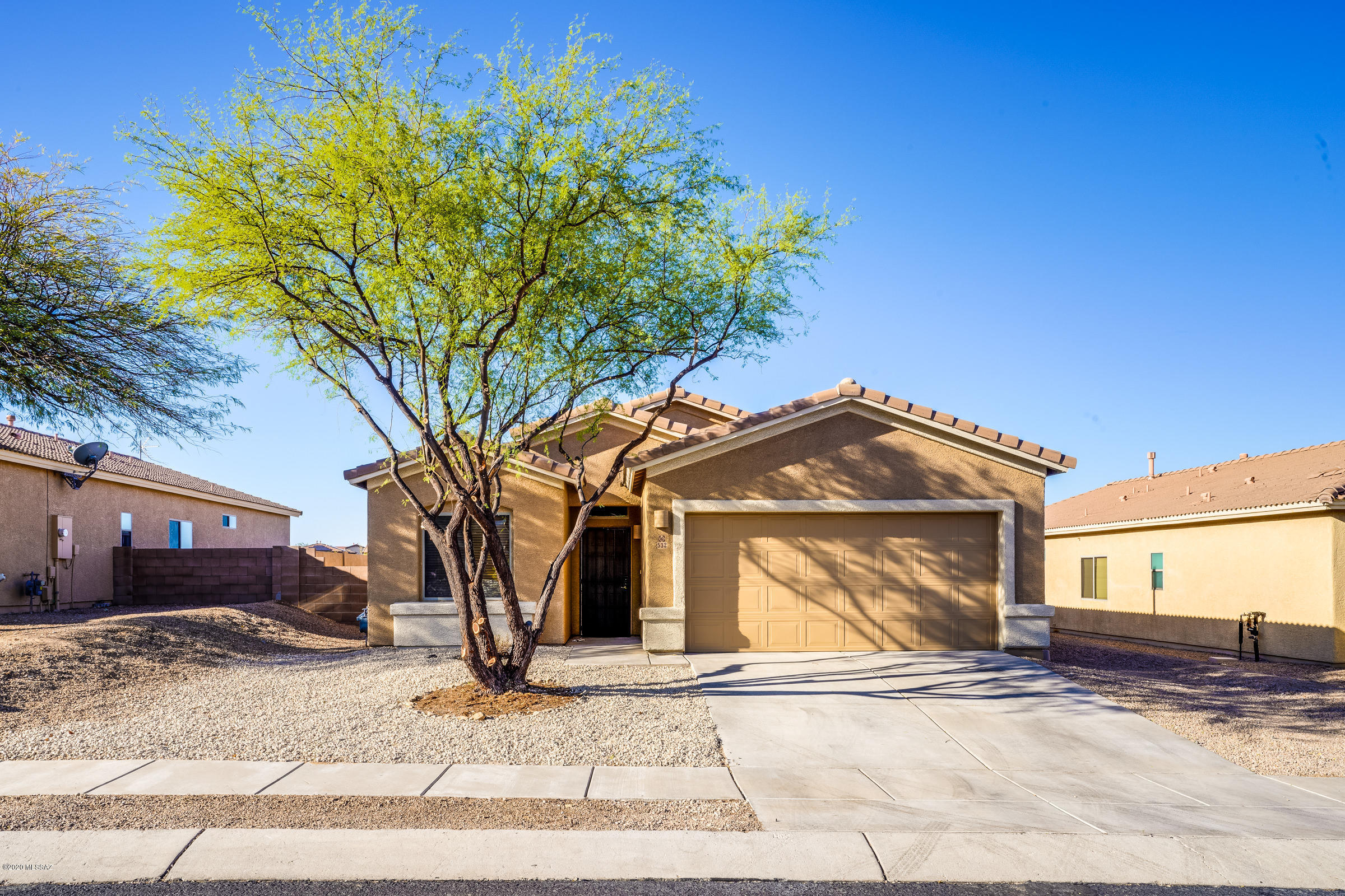 Lovely 3BD/2BA home in the highly desired Santa Rita Ranch Community is ready for its new owner. This beautiful 1,789 sqft open concept, split floor plan is perfectly laid out with a formal dining area, breakfast bar and great room. Beautiful Kitchen with huge walk-in pantry, new sink & faucet, gorgeous gas stove, dishwasher, microwave, and lots of counter space.  Freshly painted interior and exterior. Ceramic tile throughout living spaces and brand new carpet in the 3 bedrooms. One of the bedrooms has a walk out sliding door with a rolling shutter. Master Bedroom is an owner's retreat with a huge closet, separate shower, garden tub, and double sinks. Gorgeous outdoor living space with extended patio that is tiled, raised area for an outdoor spa or elevated sitting area, fountain and beautiful view. Backs up to open desert land with no neighbors directly behind you. This cozy backyard is a perfect place to relax and enjoy Arizona. Schedule your showing today!