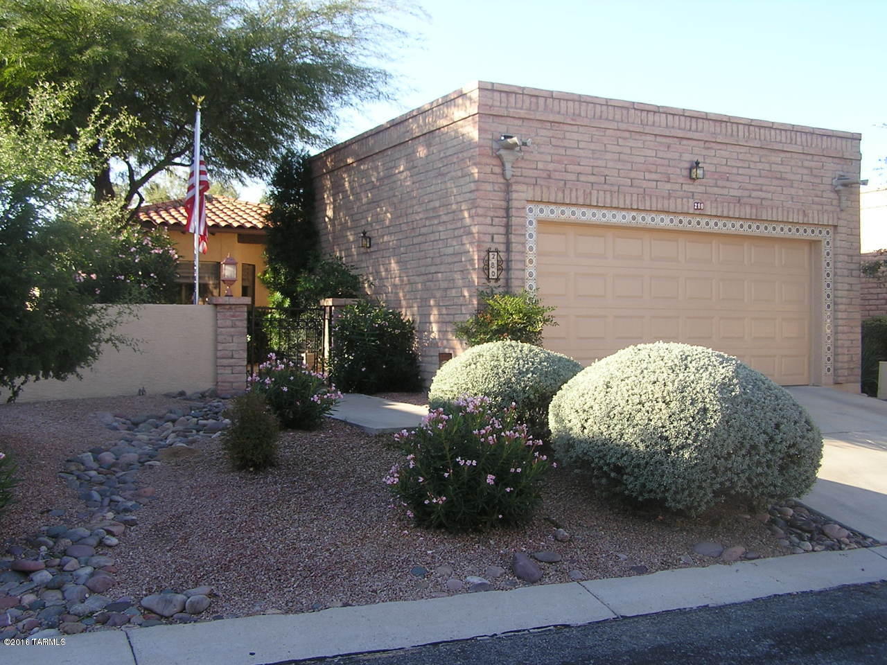 Simply GORGEOUS! Knocking on the door of Oro Valley Country Club and El conquistador this Spacious brick townhome has ROOM! Updated and Upgraded kitchen featuring granite countertops, newer cabinets stainless steel appliances INCLUDING a wine refrigerator. Glass tile mosaic backsplash for ease of care, eat in kitchen nook, and an archway opening up into the Greatroom area. Diagonally set tile floors everywhere but bedrooms. Great room is spacious bright and open featuring a fireplace. Your low care back yard features covered patio, panoramic Catalina mountain views, a water feature, pavers and plenty of low care landscaping. Two car garage features loads of storage and the washer and dryer. CLEAN and well maintained.