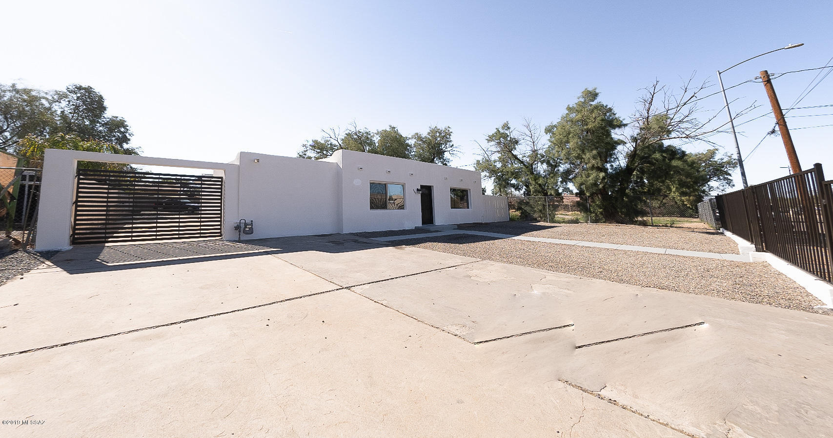 *Range Pricing: Seller will entertain offers between $175,000 and $185,000.* LOCATION, LOCATION, LOCATION! Centrally-located near the UofA & Tucson Mall within minutes. This historic home with a modern twist has been completely remodeled inside and out by an architect & has all permits. The interior features 3 bedrooms, 1.5 bathrooms, all in 1,140 SF. Beautiful, bright open floorplan, great kitchen space with upgraded granite counters & stainless steel appliances, ceramic tile flooring, tiled shower, upgraded lighting/ceiling fan fixtures throughout & a spacious laundry room.  The exterior features a large front yard, gated all around, custom modern gate leading to carport that accommodates 2 cars, and a huge backyard with covered pati. RV parking available. Won't last long!