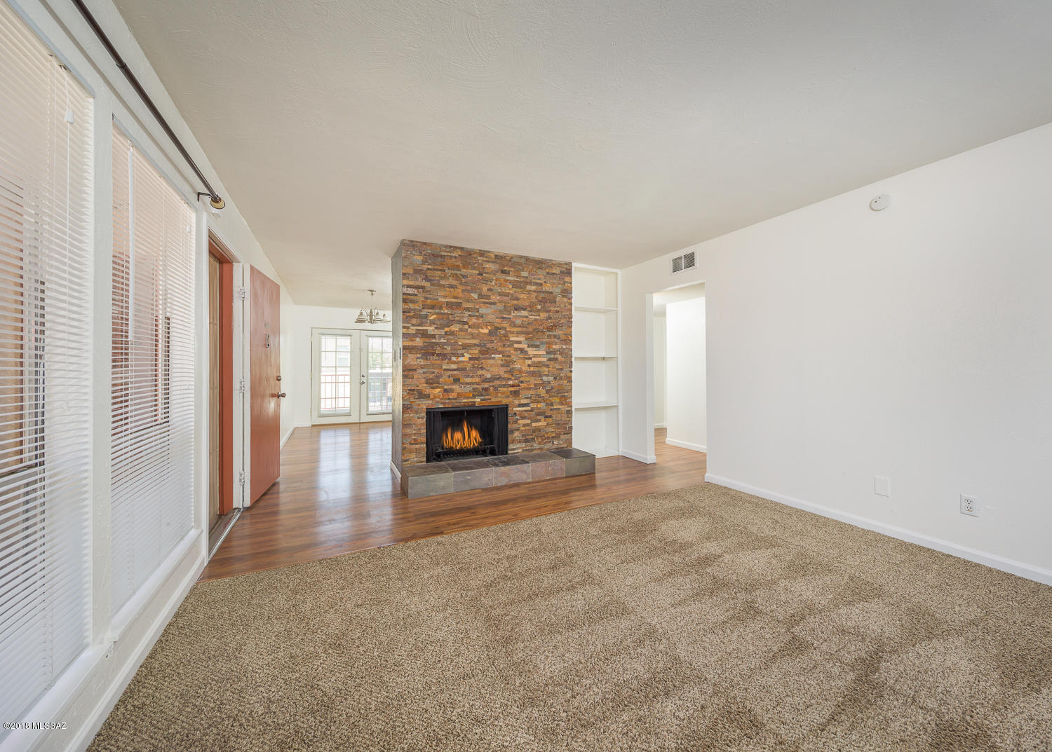 Sharp and Clean two bedroom two full bath Condo. Great Location, close to shopping, entertainment and easy commute anywhere. SS Appliances all stay. Kitchen modification opens up kitchen and gives it great feel. Newer Cabinets, Newer AC, Fresh Paint throughout this home.New Blinds, Carpets just cleaned.  Nice french doors to Covered Balcony, washer and dryer hook ups too.  Beautiful Stone fireplace. Two full Master baths, Sandstone tiled vanities. Really clean  and well cared for.  Show today. HOA pays for water, sewer, and trash and blanket insurance policy.